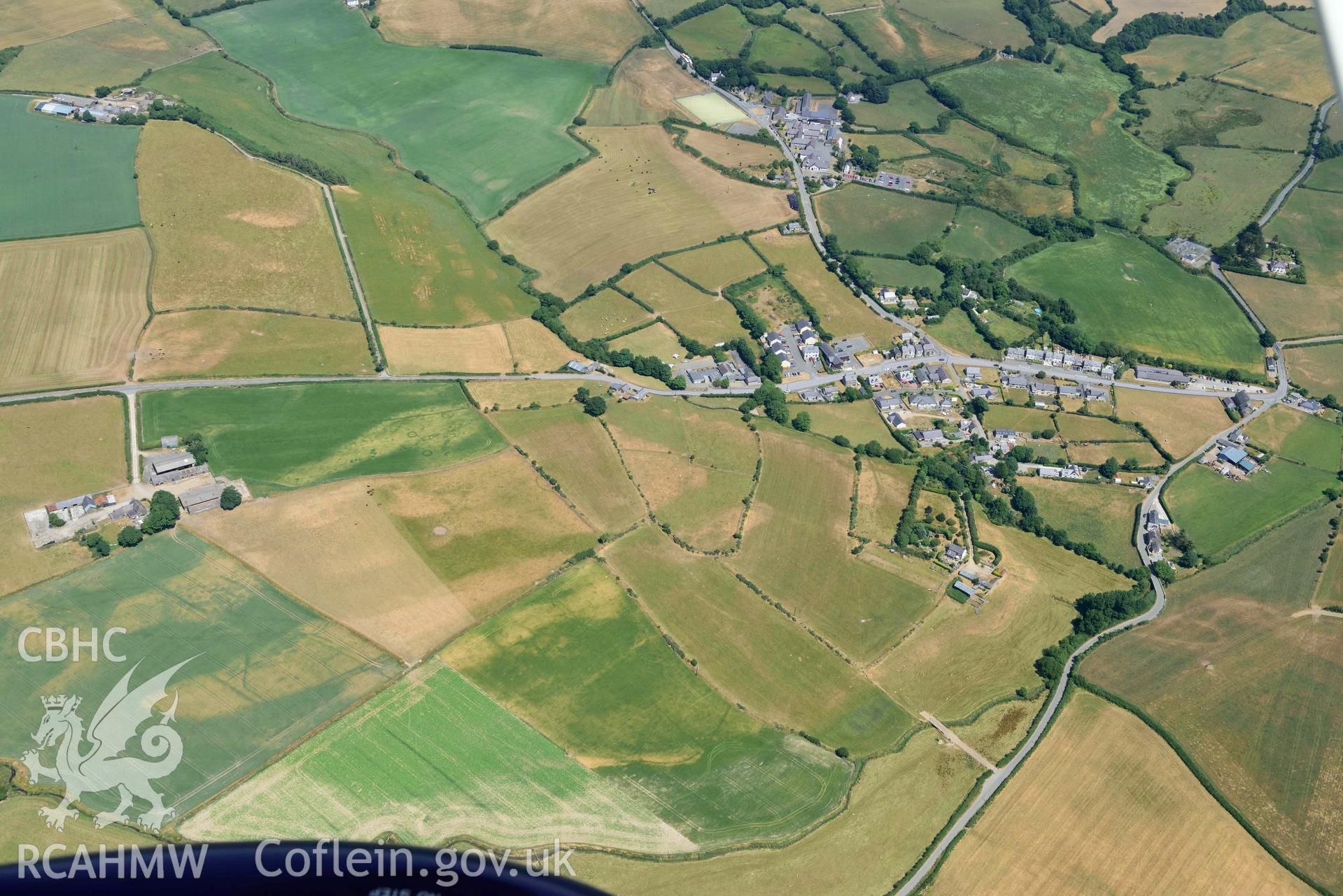 Bodnithoedd barrow cemetery and Botwnnog village. Oblique aerial photograph taken during the Royal Commission’s programme of archaeological aerial reconnaissance by Toby Driver on 10 July 2018.