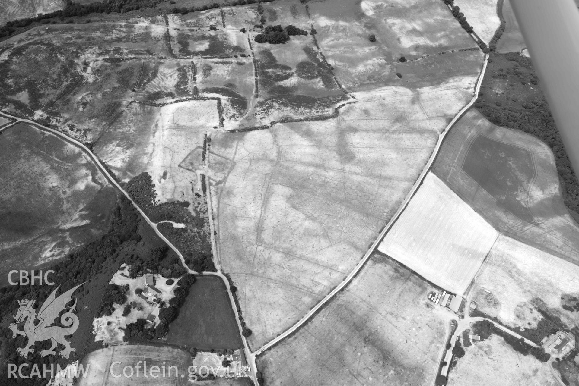 Traian rectangular enclosure. Oblique black and white aerial photograph taken during the Royal Commission’s programme of archaeological aerial reconnaissance by Toby Driver on 10 July 2018.