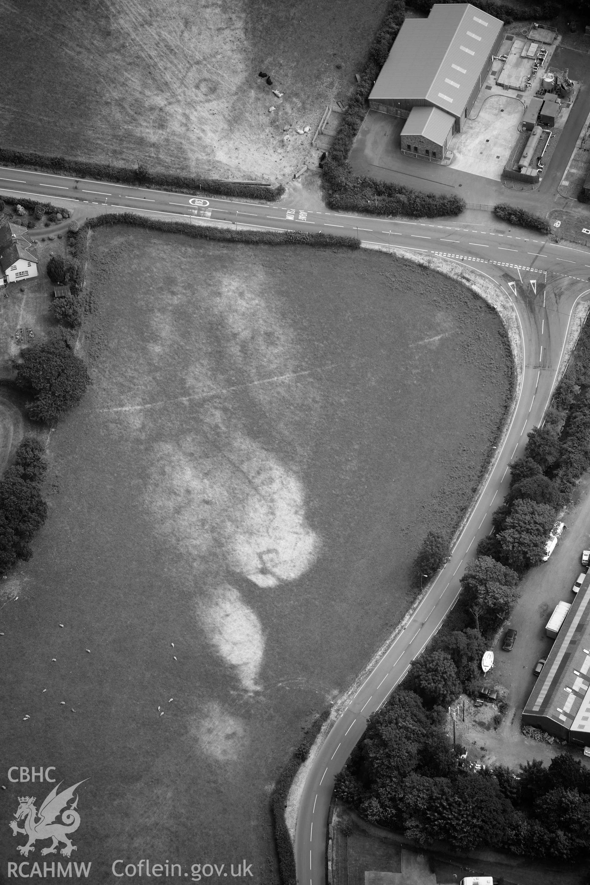 Bryncrug square barrow. Oblique black and whiteaerial photograph taken during the Royal Commission’s programme of archaeological aerial reconnaissance by Toby Driver on 10 July 2018.