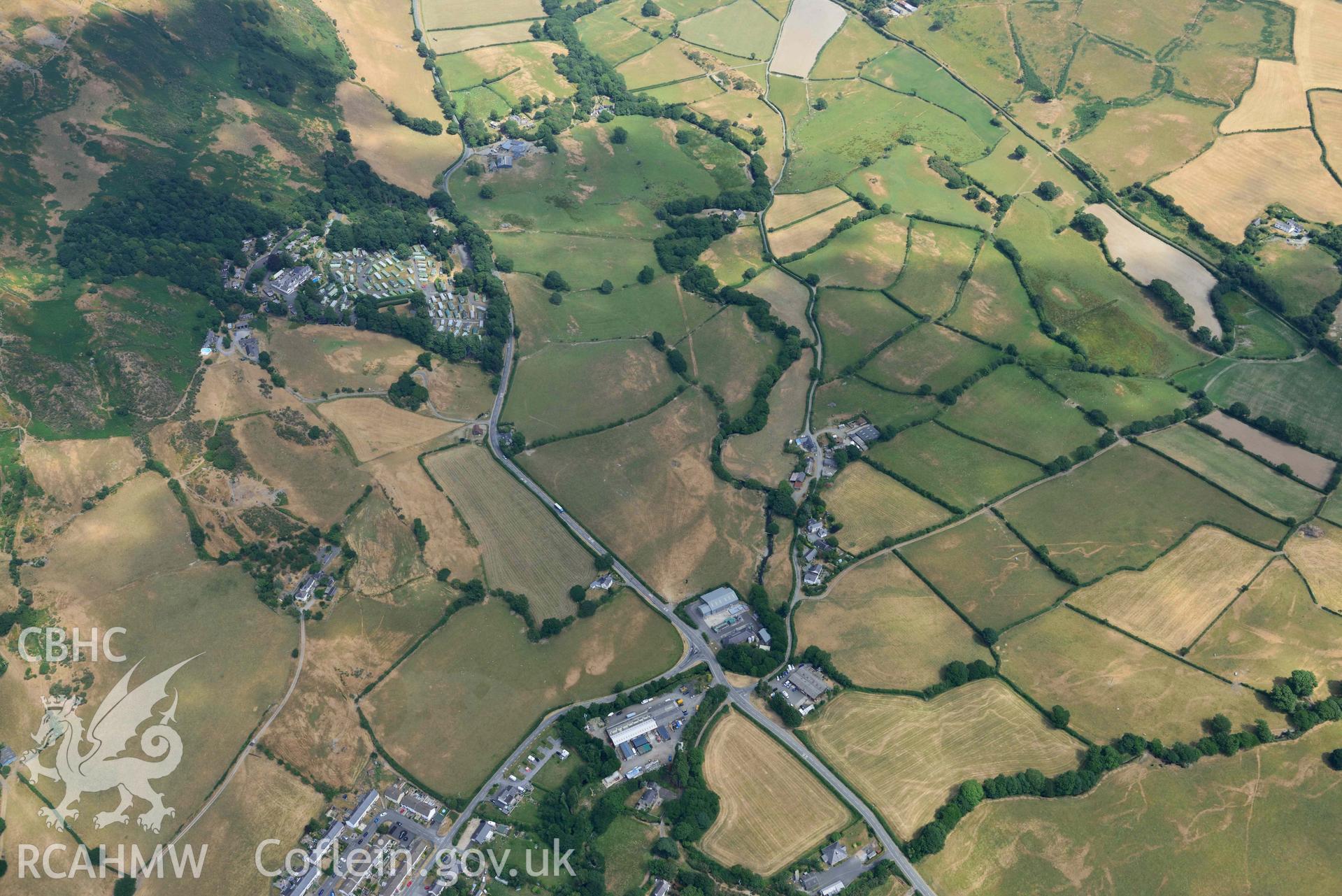 Bryncrug Pont y Felindre cropmarks and surrounding landscape. Oblique aerial photograph taken during the Royal Commission’s programme of archaeological aerial reconnaissance by Toby Driver on 10 July 2018.