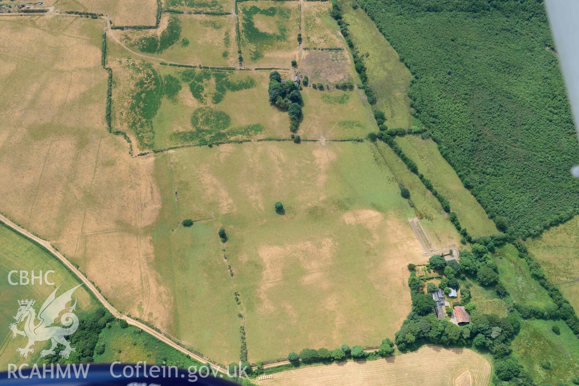 Traian bivallate cropmark enclosure. Oblique aerial photograph taken during the Royal Commission’s programme of archaeological aerial reconnaissance by Toby Driver on 10 July 2018.