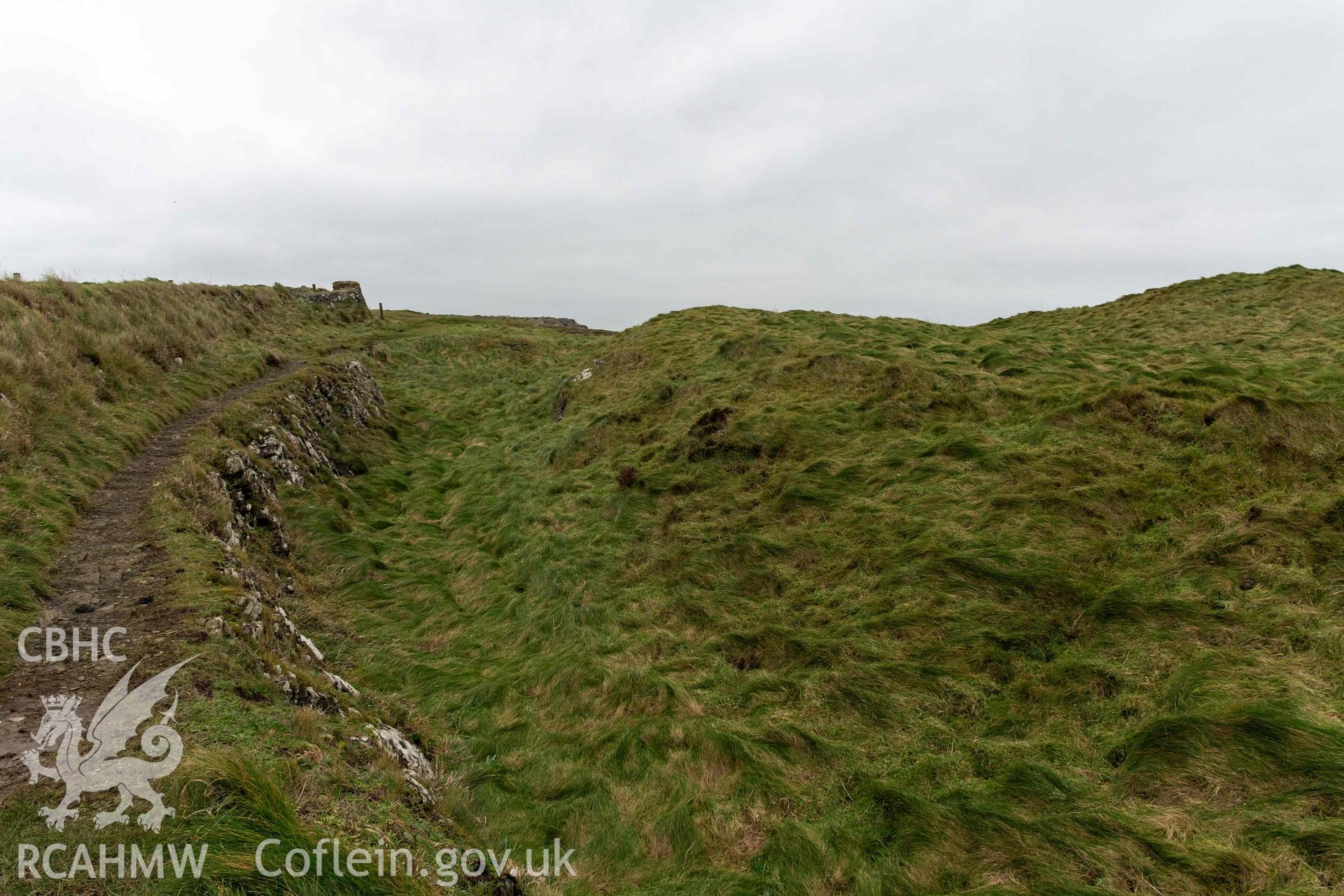 Castell Coch Promontory Fort. Outer rock-cut ditch and scarp, looking south.