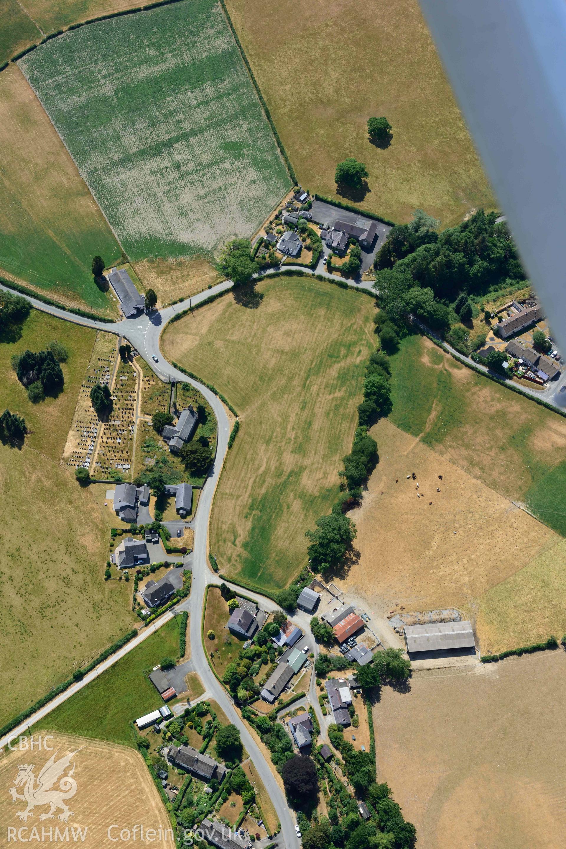 St Afan's Church and Llanafan rectangular enclosure. Oblique aerial photograph taken during the Royal Commission’s programme of archaeological aerial reconnaissance by Toby Driver on 10 July 2018.
