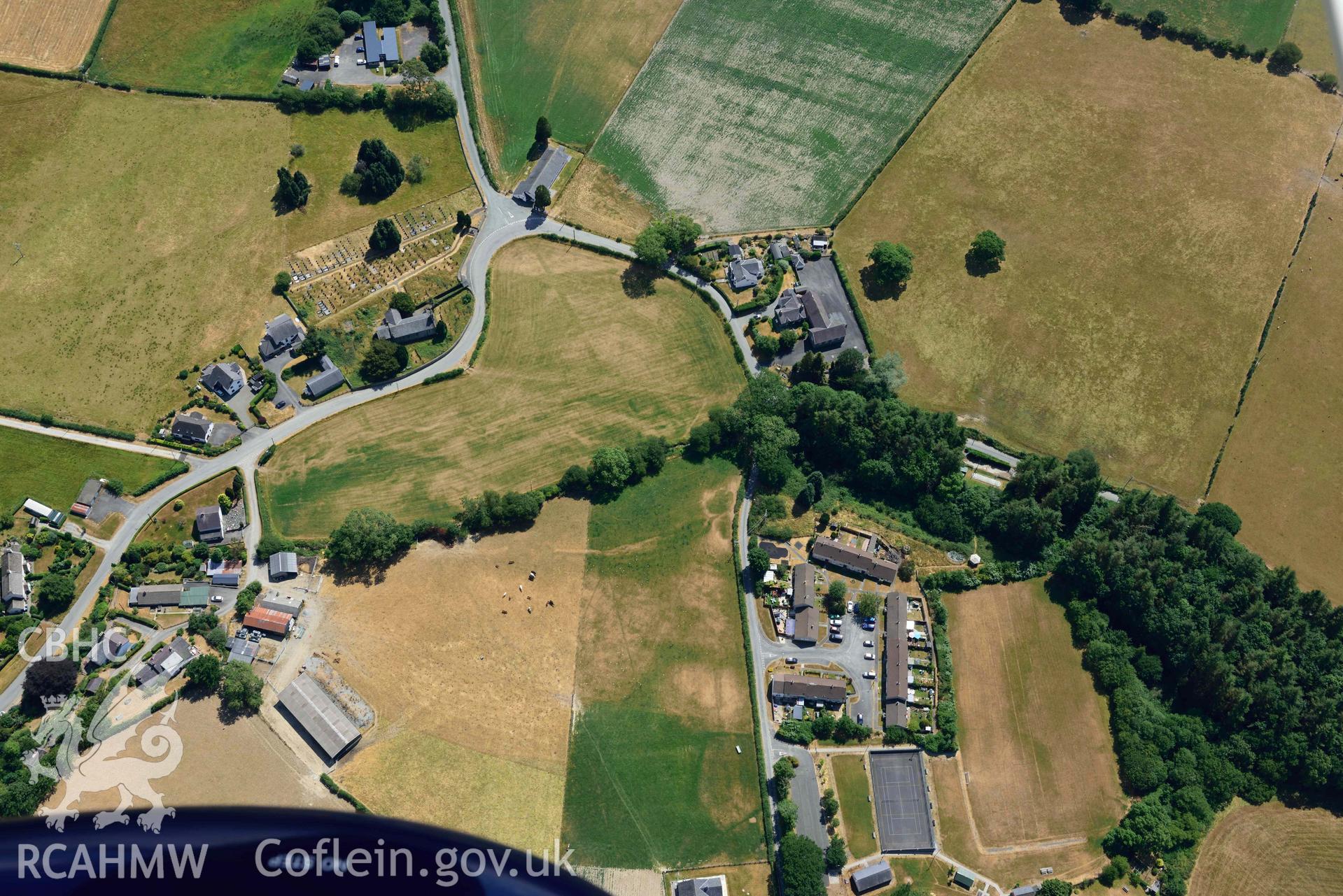 General view of St Afan's Church and Llanafan rectangular enclosure. Oblique aerial photograph taken during the Royal Commission’s programme of archaeological aerial reconnaissance by Toby Driver on 10 July 2018.