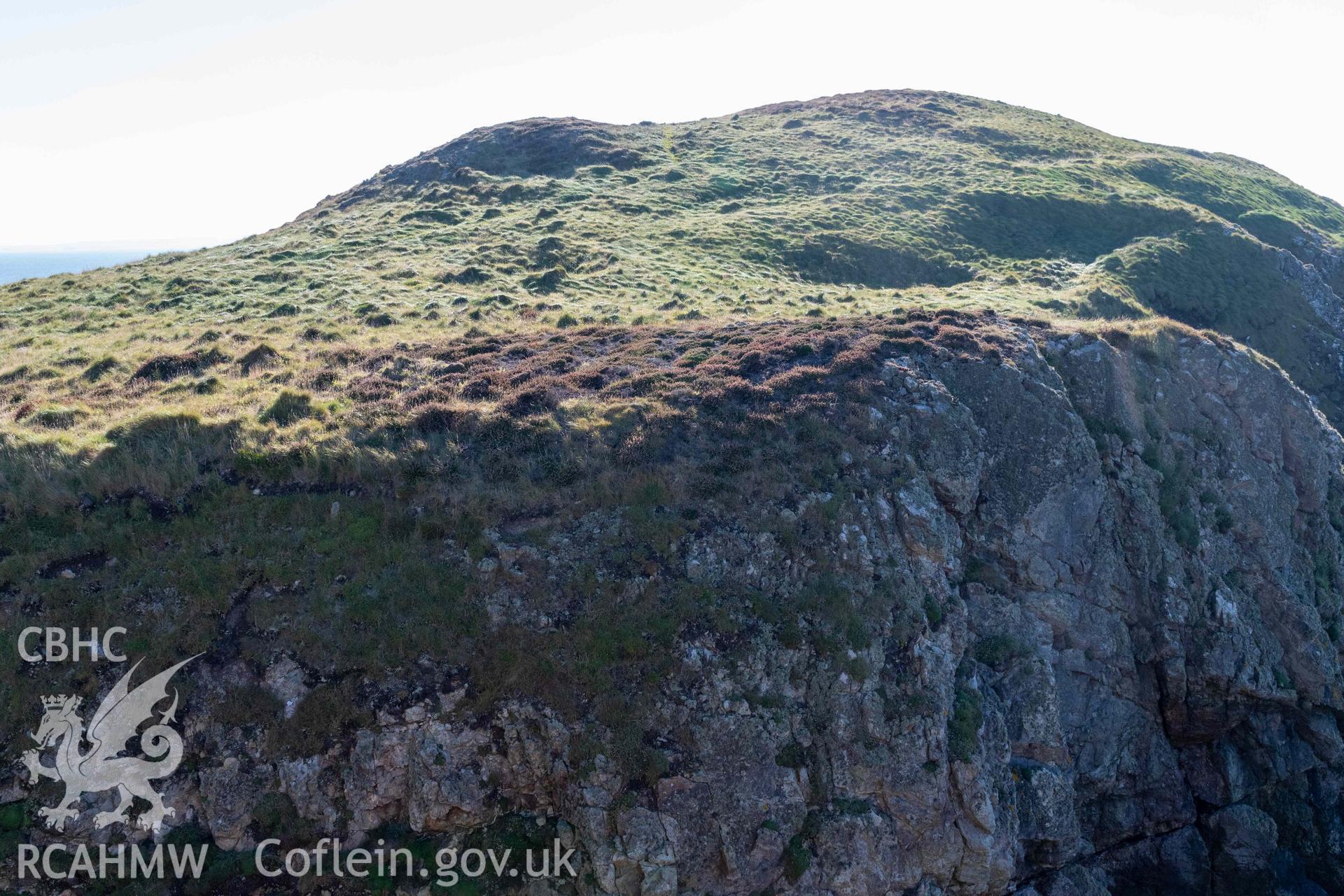 Ynys y Fydlyn Coastal Promontory Fort. View of house platforms, accentuated in low light on western islet. Taken looking west from eastern islet.