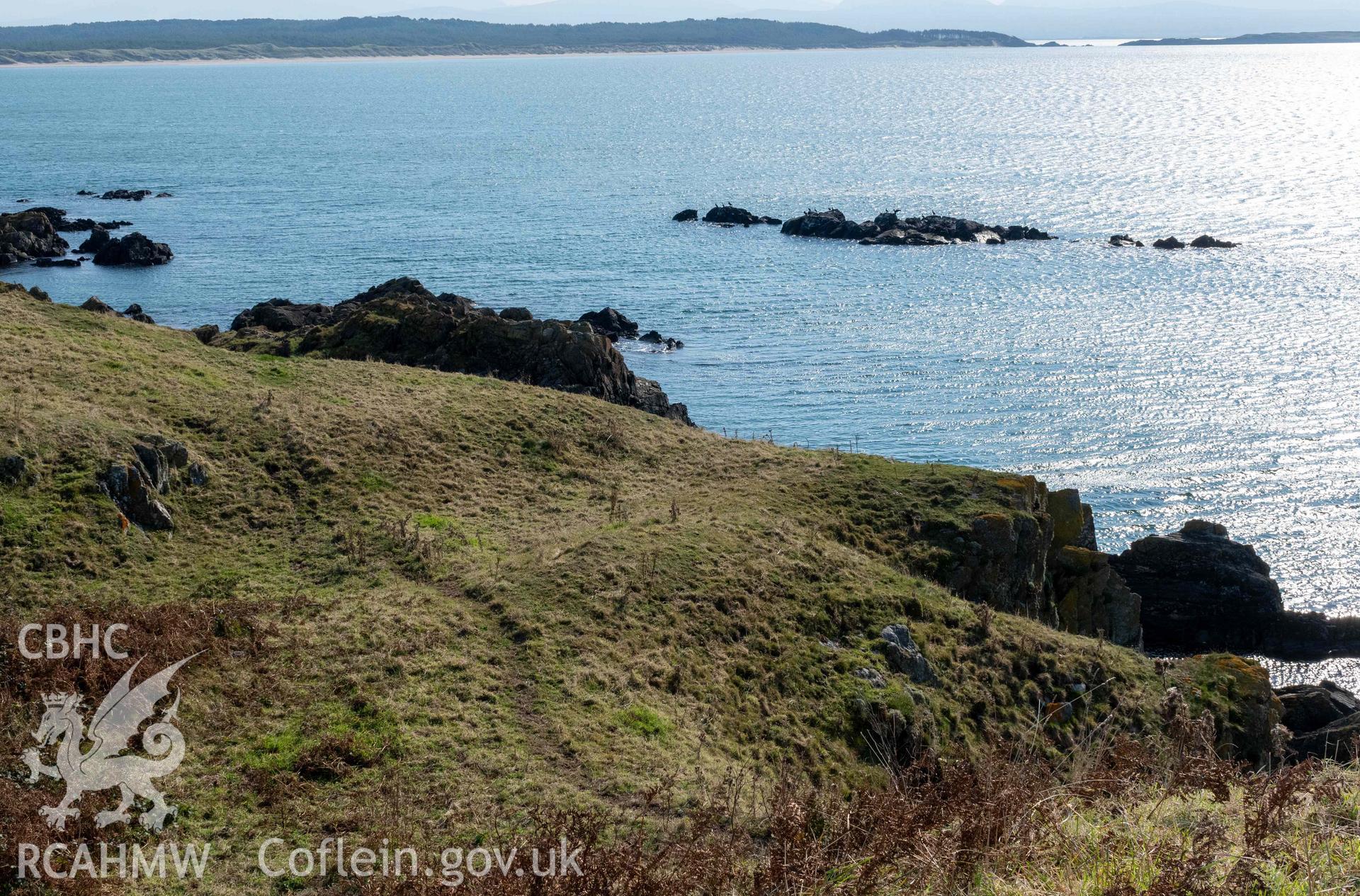 Twyn y Parc Coastal Promontory Fort. View east from top of inner rampart across outer ditch and Malltraeth Bay.