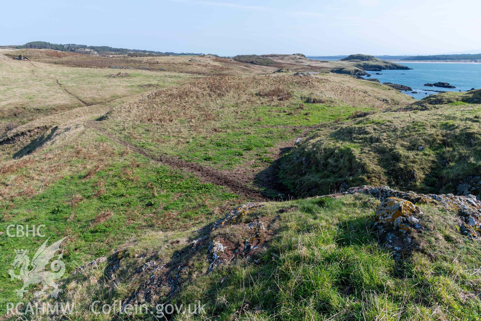 Twyn y Parc Coastal Promontory Fort. Looking northeast from a rock otcrop across the level terrace area behind the inner rampart.
