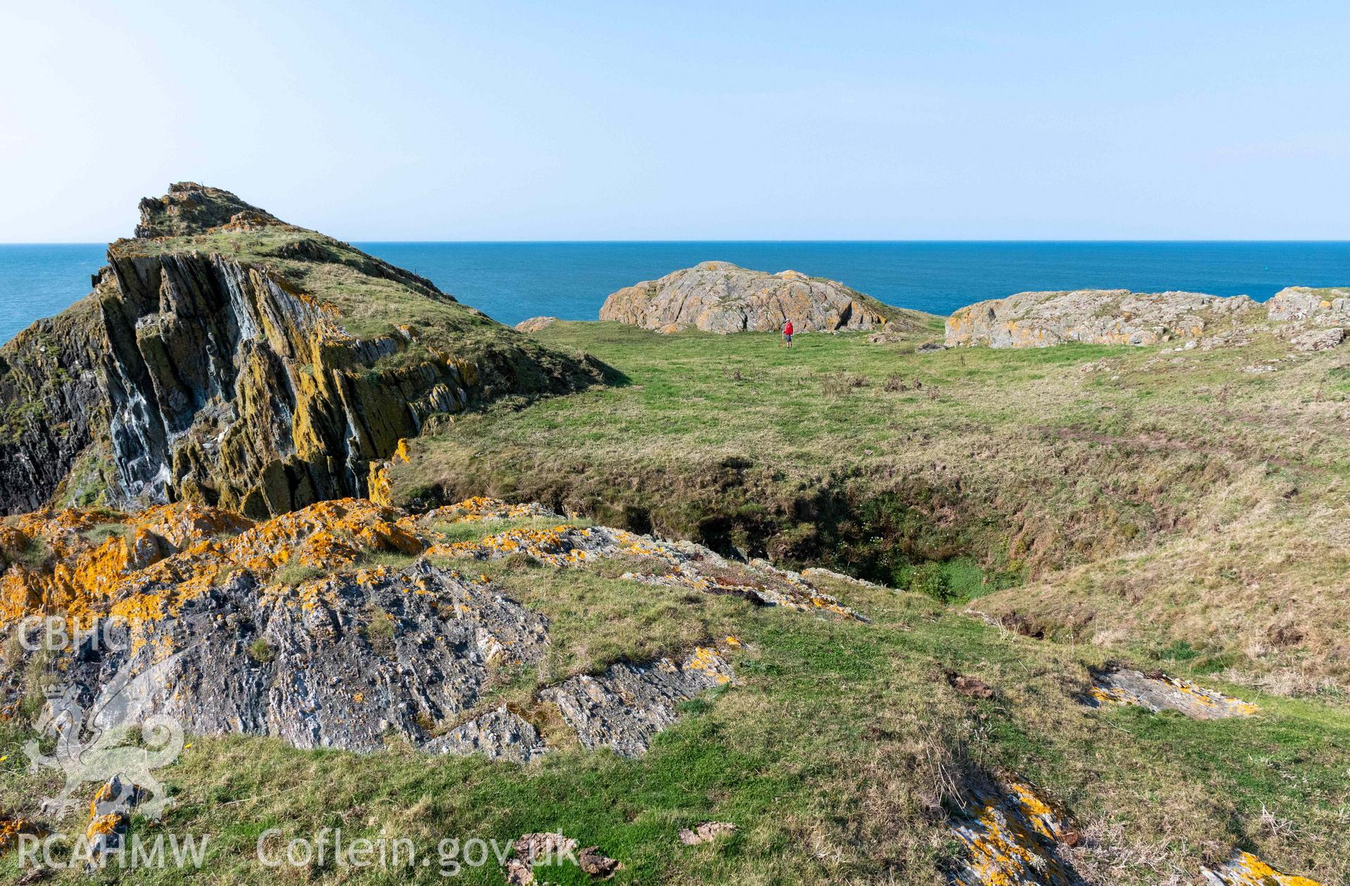 Twyn y Parc Coastal Promontory Fort. Level interior terrace area (with person) between rock outcrops at the southwestern edge of the fort.