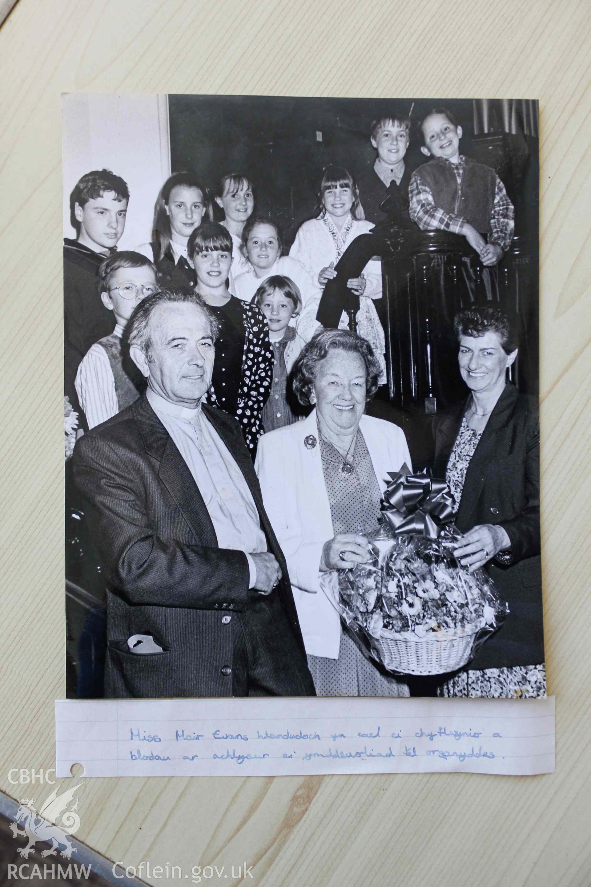Black and white photograph of Mair Evans presented with flowers on her retirement as organist. Tabernacl Cardigan