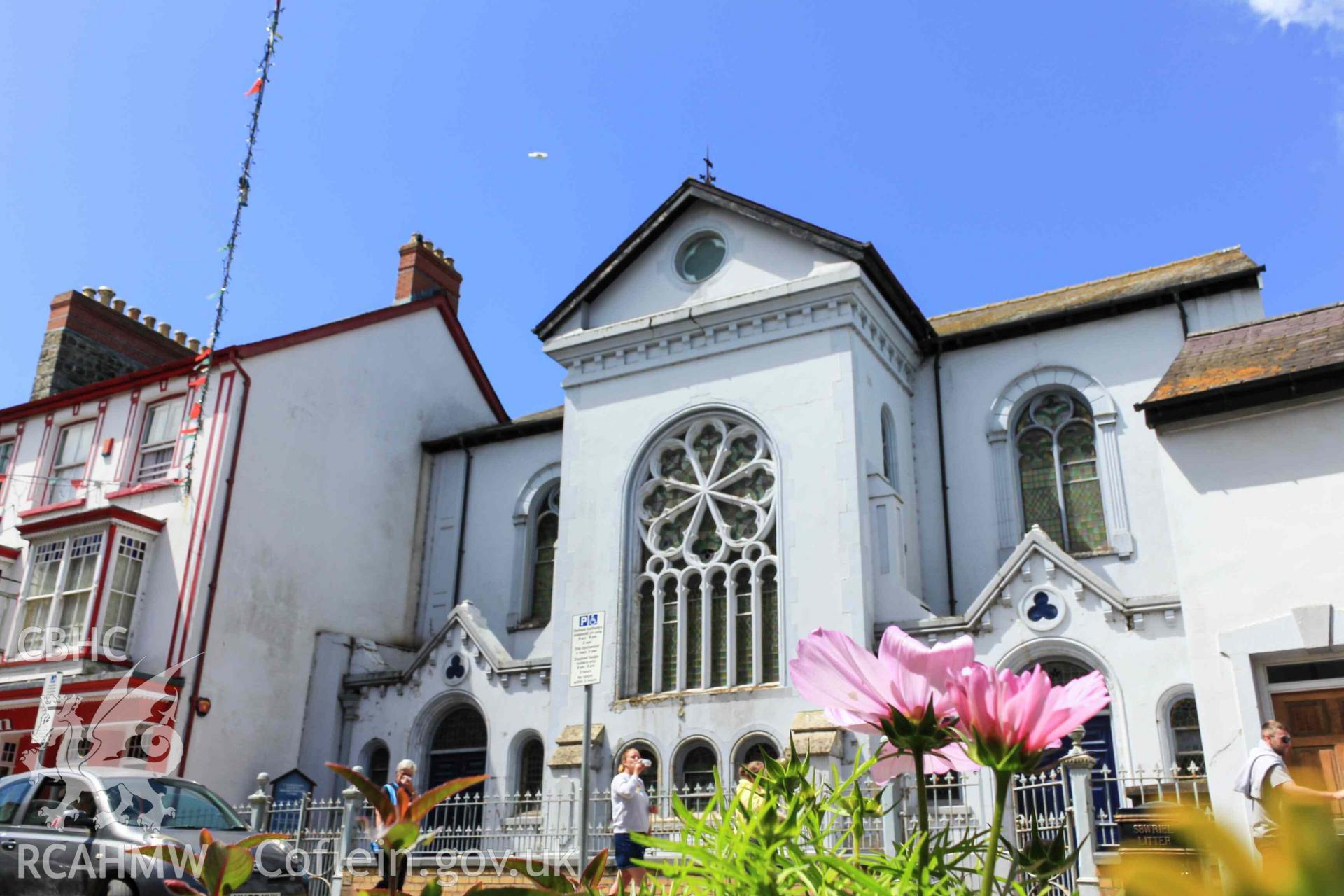 Exterior across the road of Tabernacl Cardigan with flowers in foreground