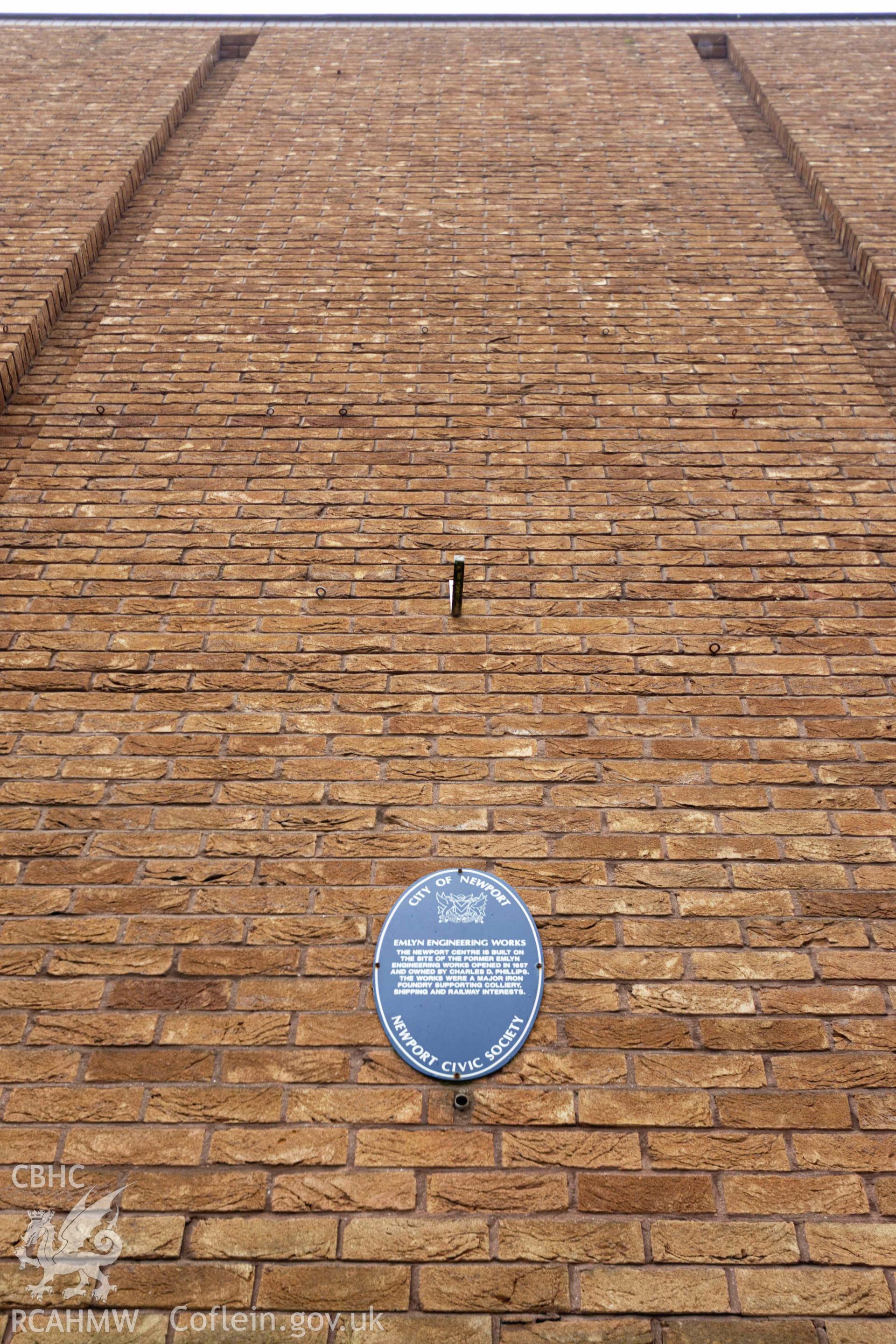Newport Civic Society blue plaque noting site of former Emlyn Engineering Works (opened 1857). 'The Newport Centre is built on the site of the former Emlyn Engineering Works opened in 1857 and owned by Charles D. Phillips. The works were a major iron foundry supporting colliery, shipping and railway interests.' Newport Centre