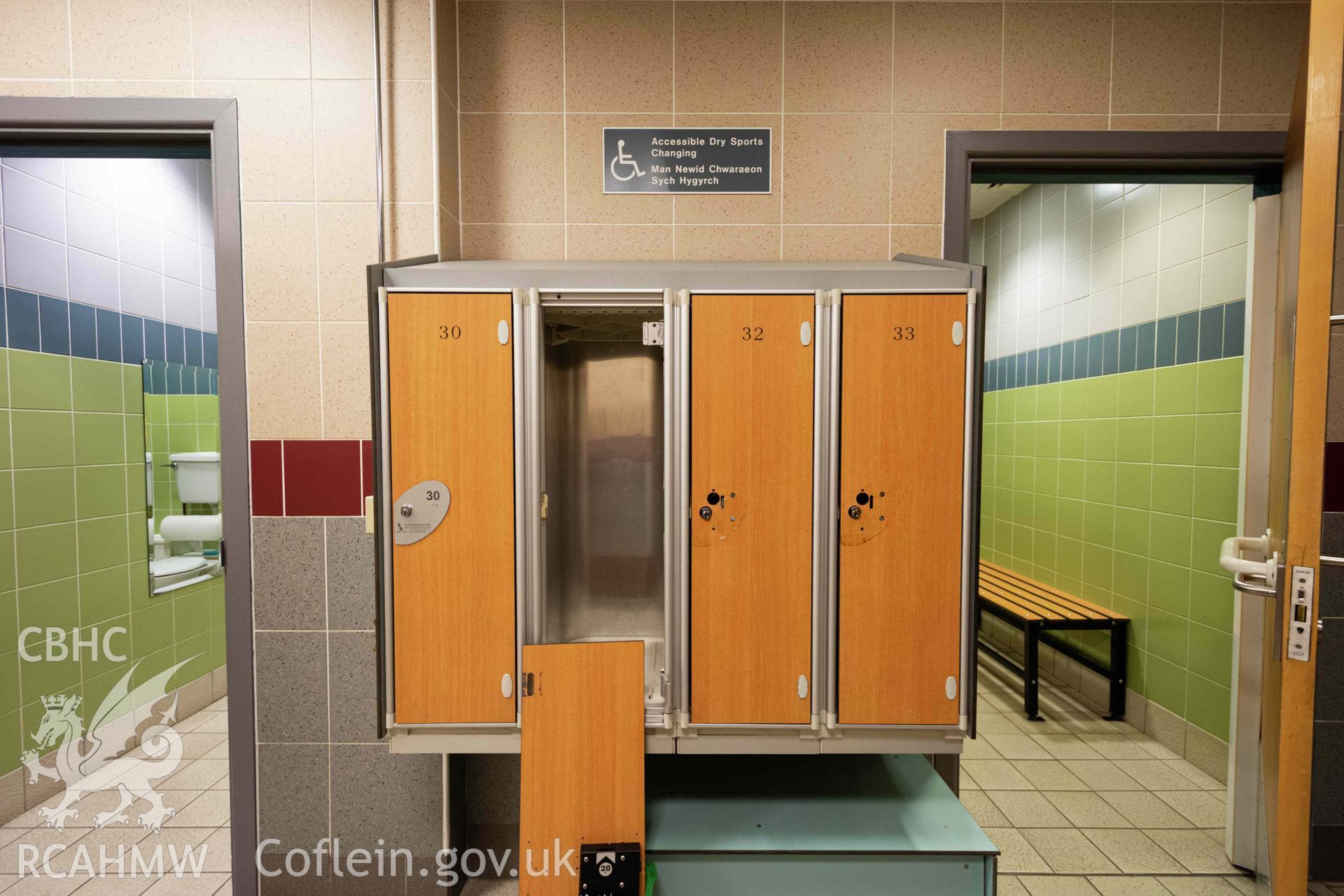 Lockers, one damaged. 'Accessible Dry Sports Changing / Man Newid Chwaraeon Sych Hygyrch'. Ground floor. Newport Centre