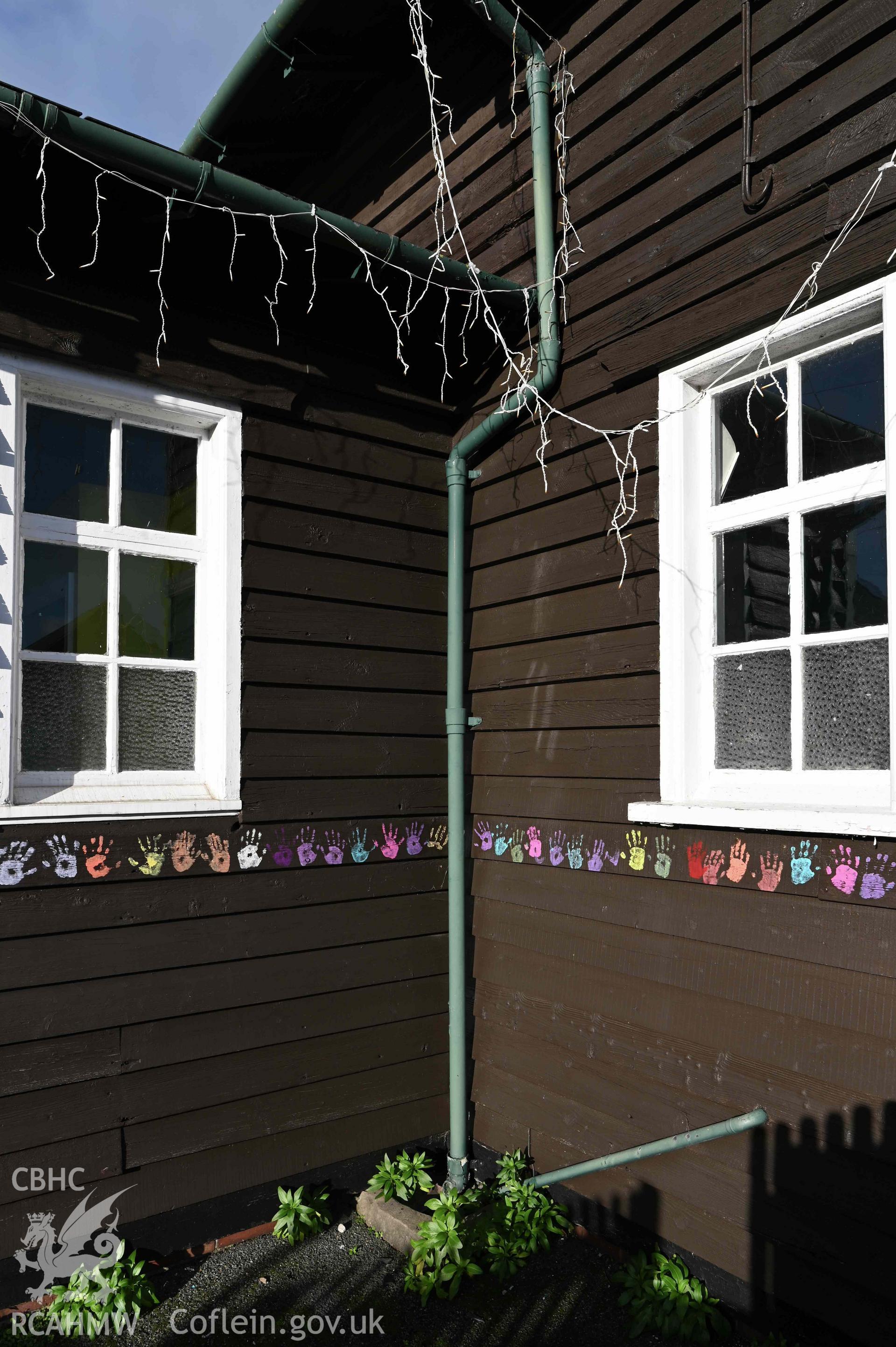 Angle between porch and main building of Ysgol Abersoch decorated with pupils handprints