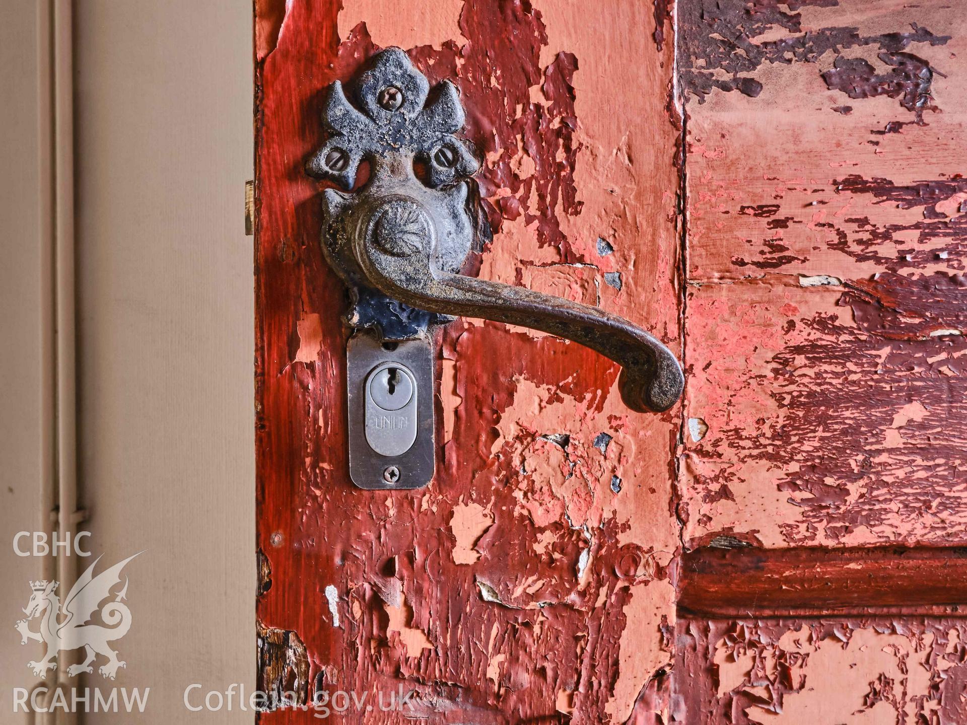 Photograph showing door handle ground floor, from a Level 3 Historic Building Record for The Old Probate Registry, Llandaff, Cardiff. Prepared by Holland Heritage in 2024 as a condition of listed planning consent.