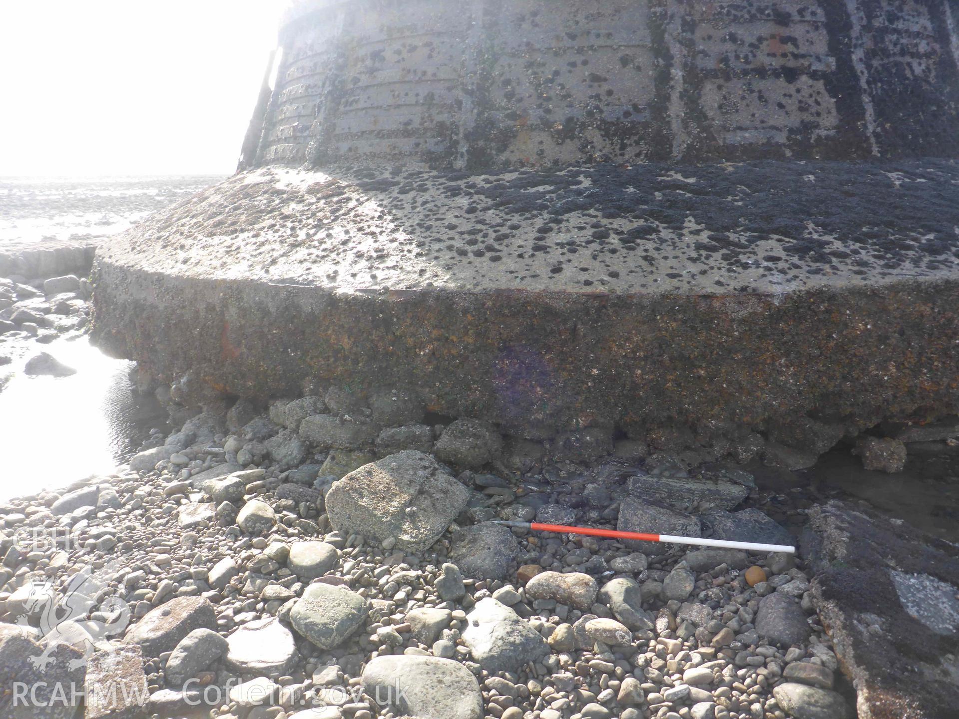 Whitford Point Lighthouse on 17/10/2024. View of the scour and plinth on the northeastern side of the lighthouse. Scale is 1m