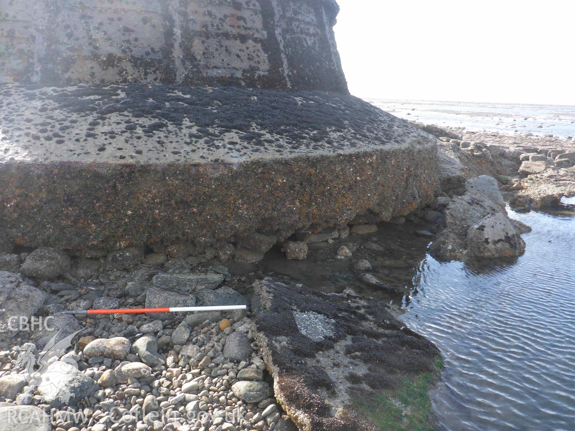 Whitford Point Lighthouse on 17/10/2024. View of the scour and plinth on the northeastern side of the lighthouse. Scale is 1m