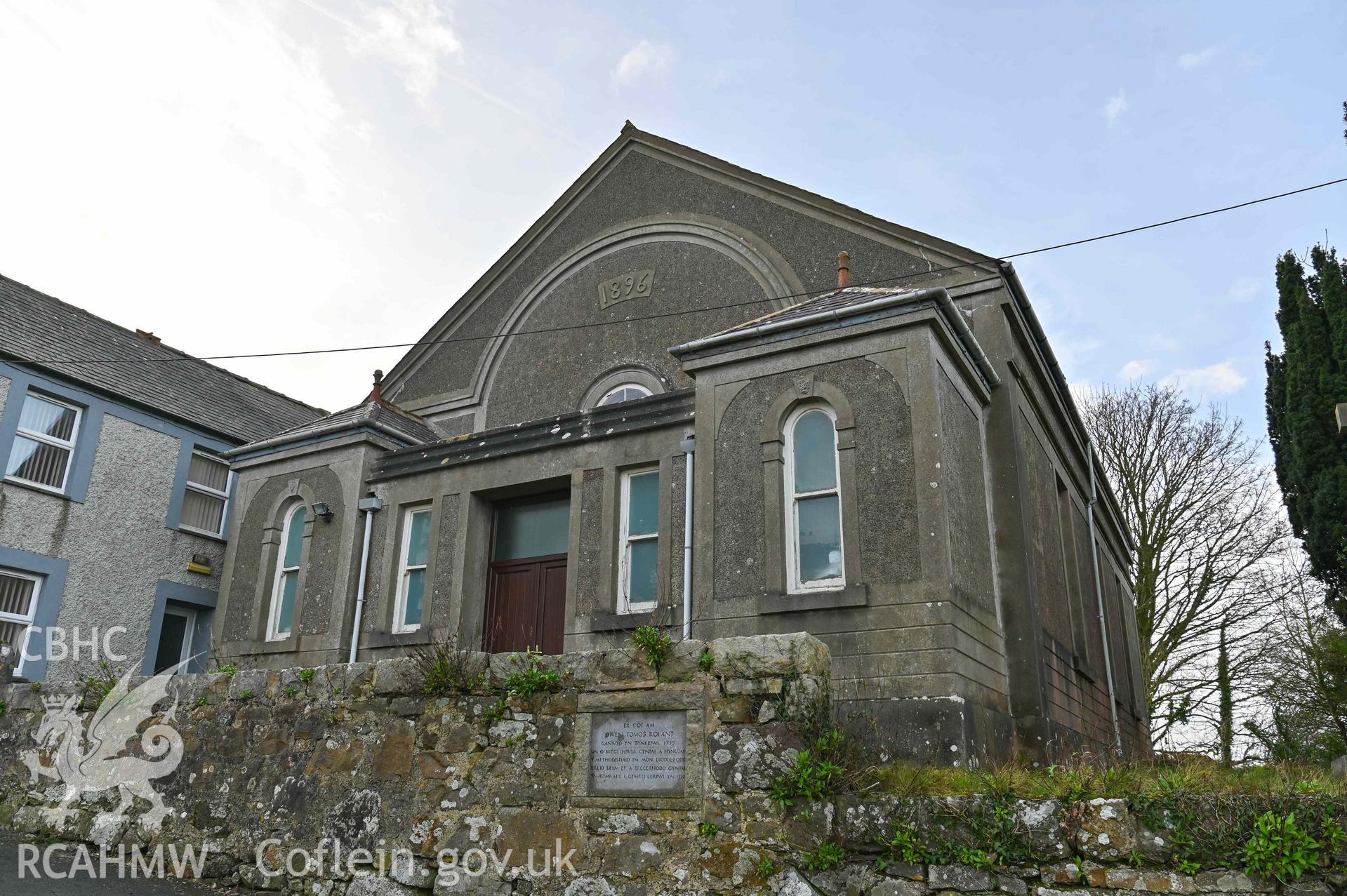 Brynyrefail Chapel - Angled view of the front and side of the chapel, plaque on entrance wall visible, taken from North