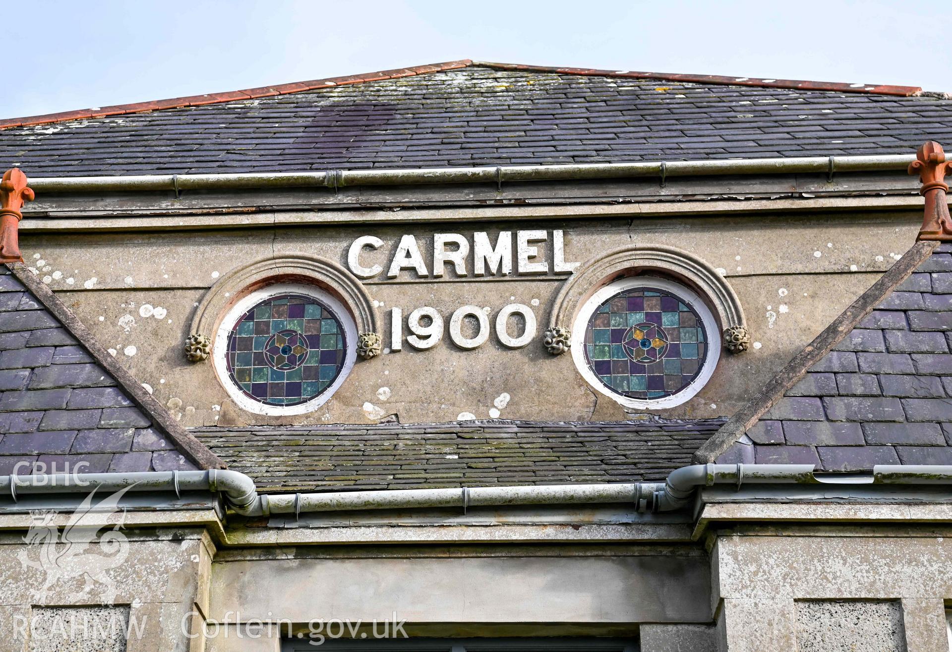 Carmel Welsh Baptist Church - Detailed view of the stained glass windows and church name above the entrance, taken from West