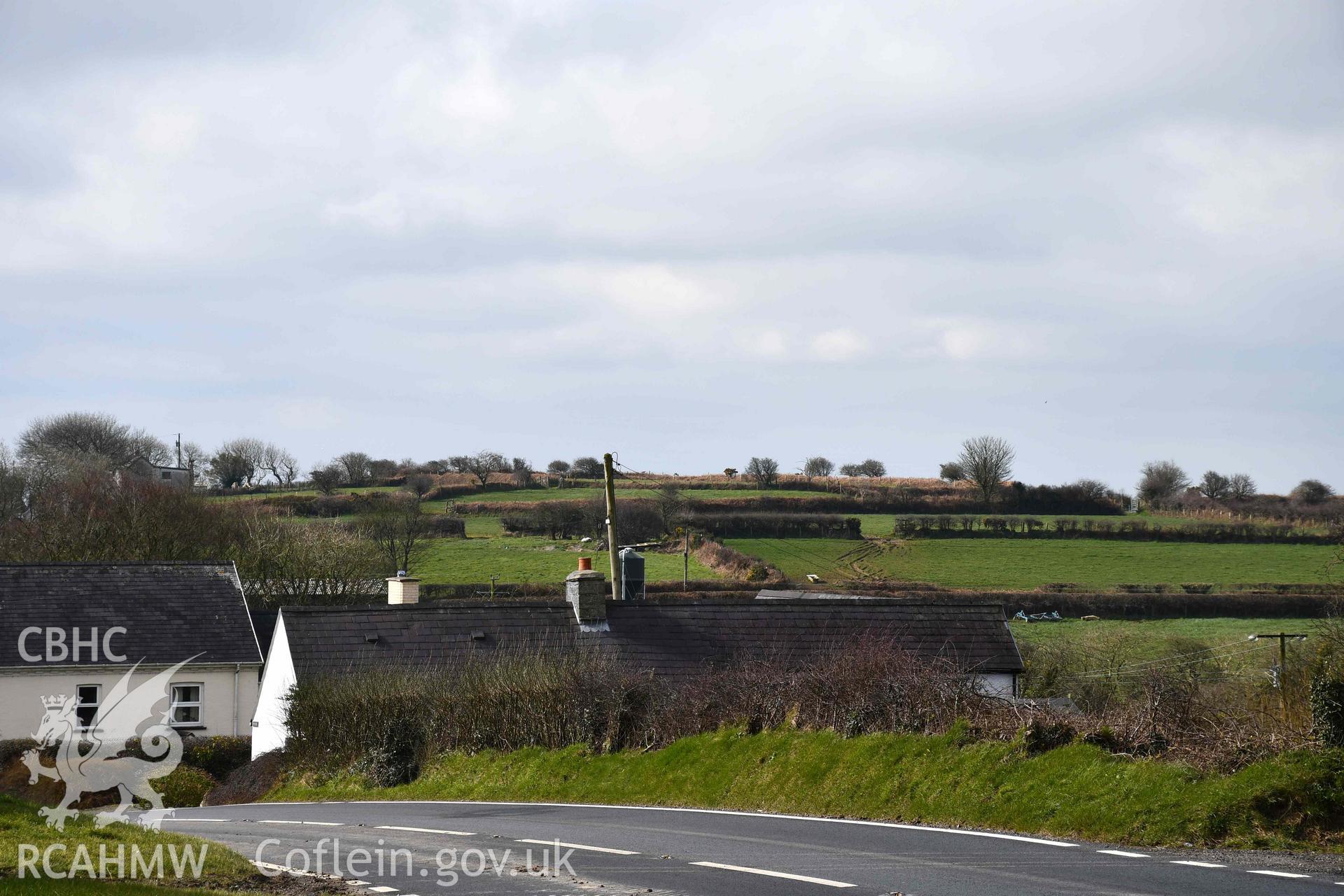 Castell Nadolig: landscape view of hillfort earthworks from A487 road to the east