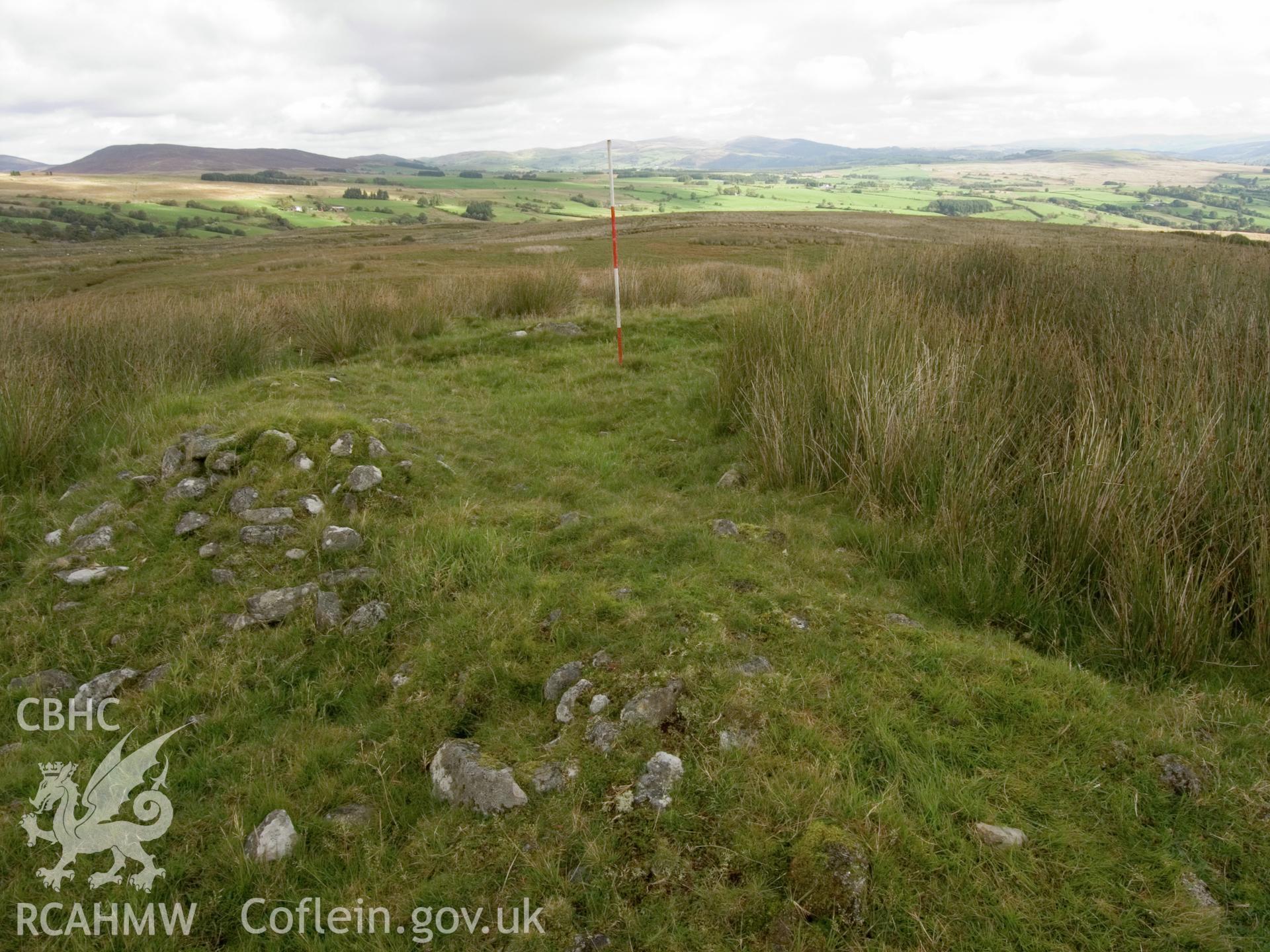 View looking NE showing the exposed NW side of the cairn.
