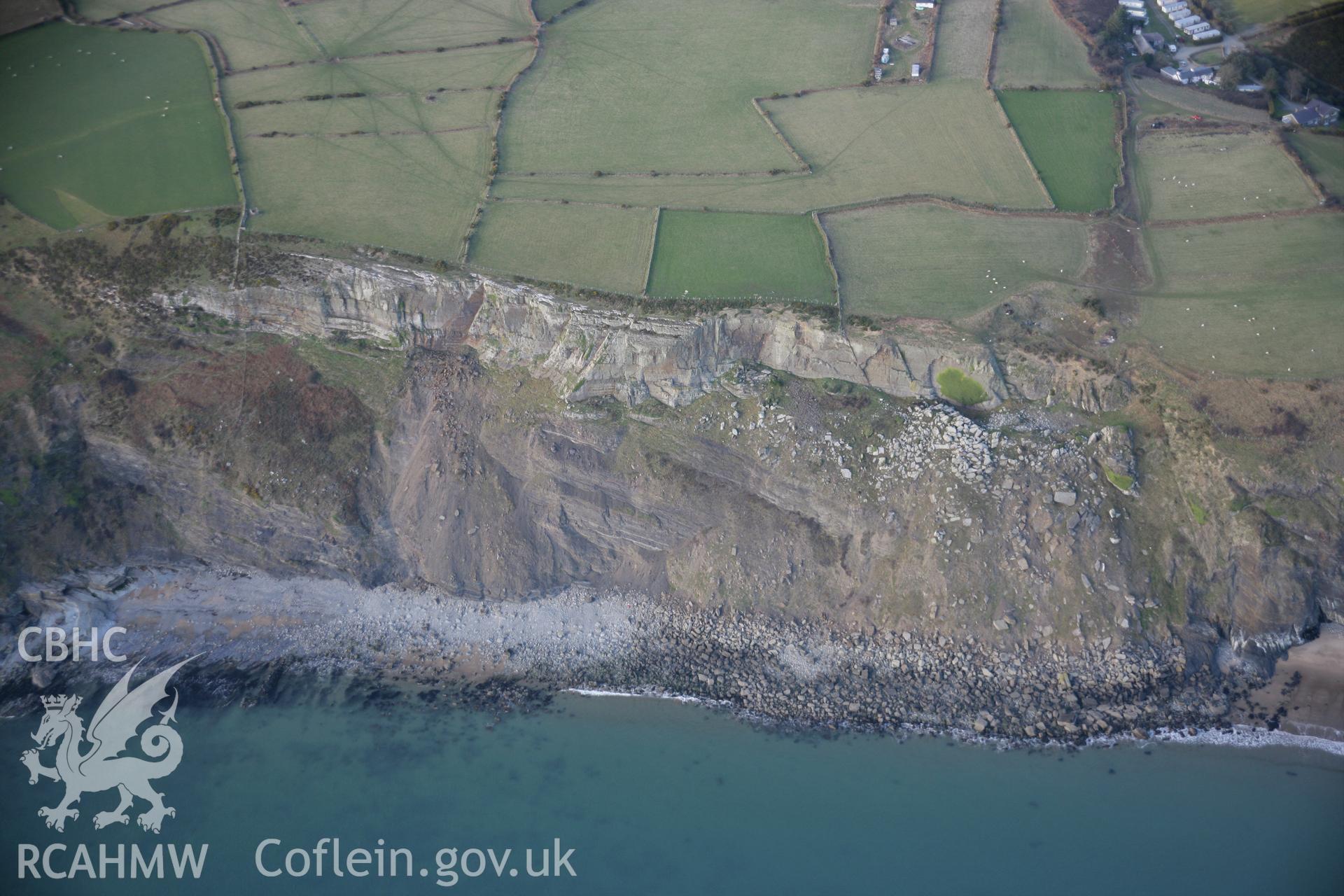 RCAHMW colour oblique aerial photograph of Pared Mawr Camp with promontory fort, Porth Ceiriad, showing coastal erosion to the north-east, viewed from the south. Taken on 09 February 2006 by Toby Driver.