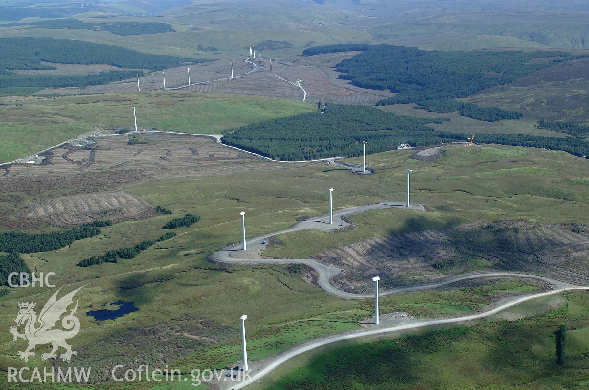 RCAHMW colour oblique aerial photograph of Cefn Croes Wind Farm during construction, looking east. Taken on 31 August 2004 by Toby Driver