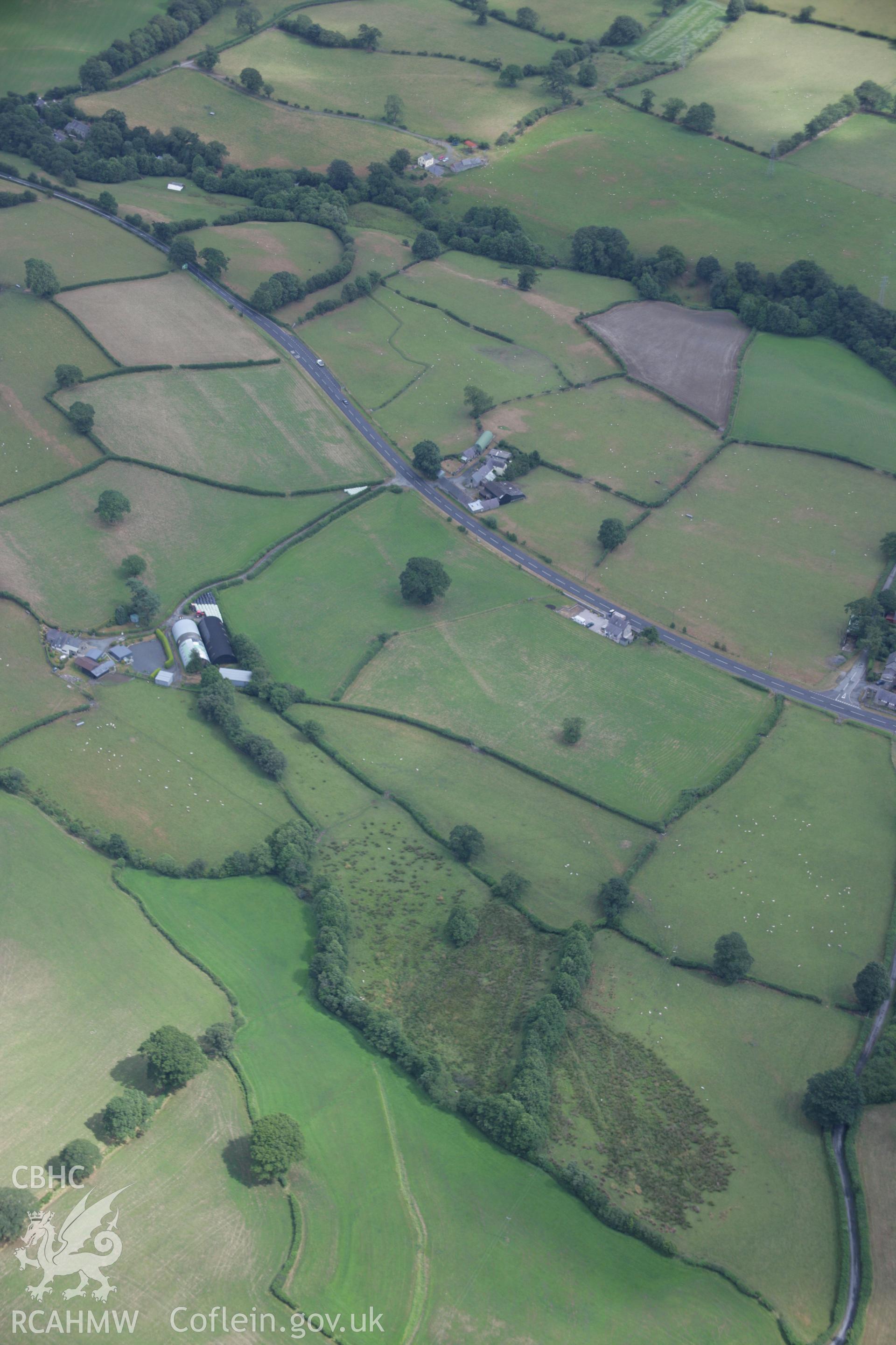 RCAHMW colour oblique aerial photograph of the Roman road between Four Crosses and Druid at Bryncoch. Taken on 31 July 2006 by Toby Driver.