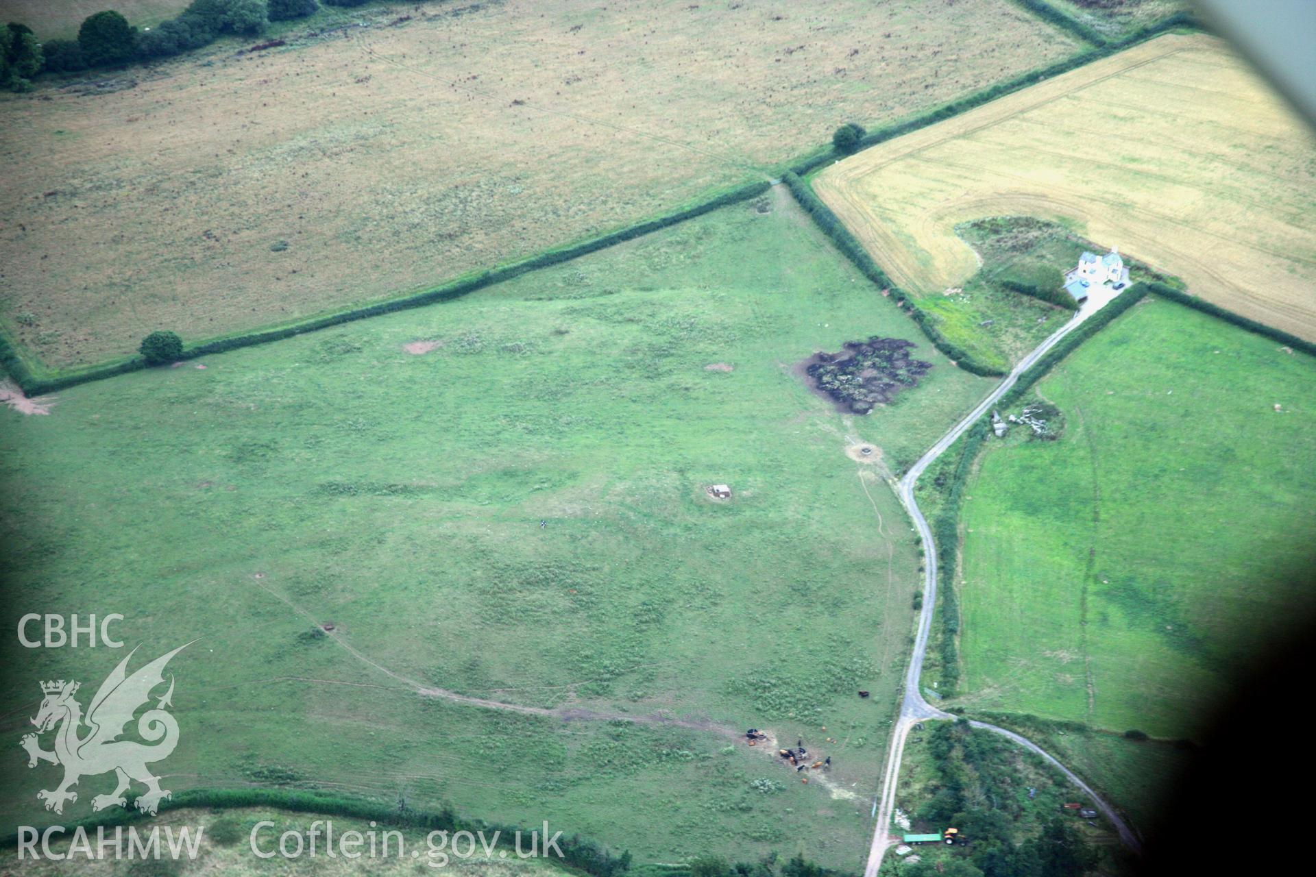 RCAHMW colour oblique aerial photograph of siege earthworks north-east of Raglan Castle. Taken on 05 August 2006 by Toby Driver
