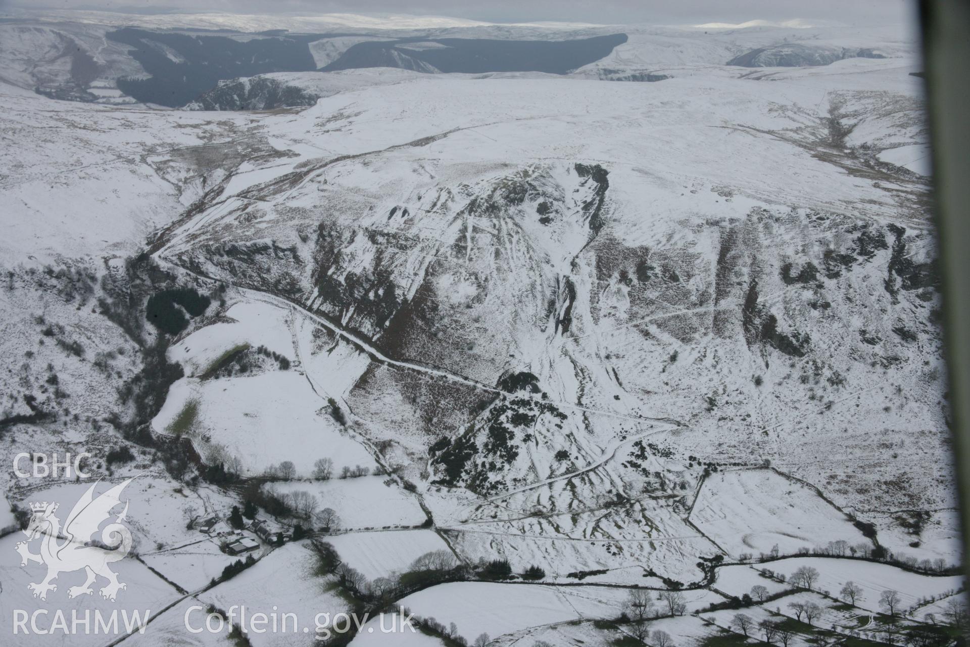 RCAHMW colour oblique aerial photograph of Craig-y-Mwyn Lead Mine, Llanrhaeadr-Ym-Mochnant, from the north-east under snow. Taken on 06 March 2006 by Toby Driver.