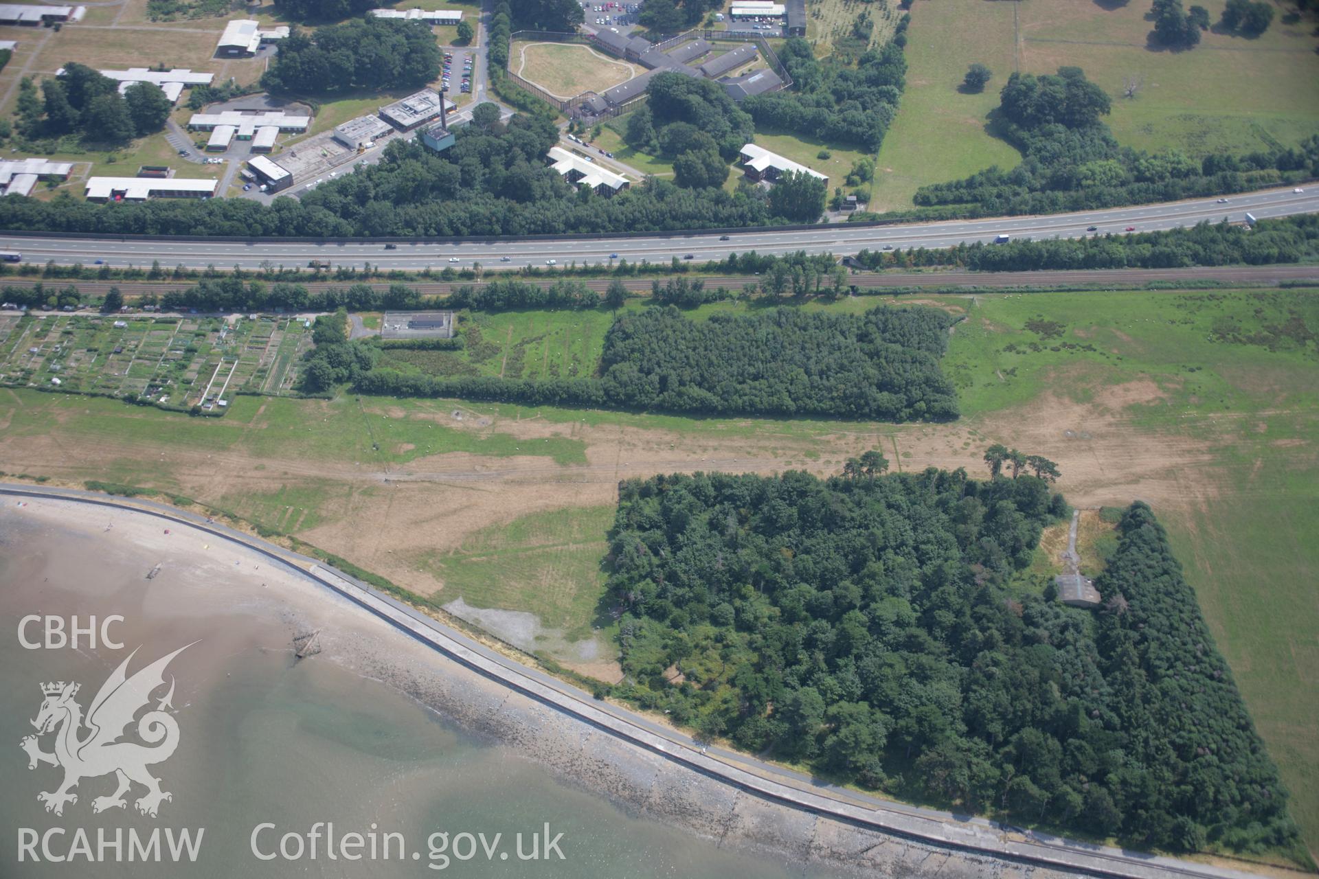 RCAHMW colour oblique aerial photograph of various cropmarks near Bryn-y-Neuadd Garden, Llanfairfechan. Taken on 25 July 2006 by Toby Driver