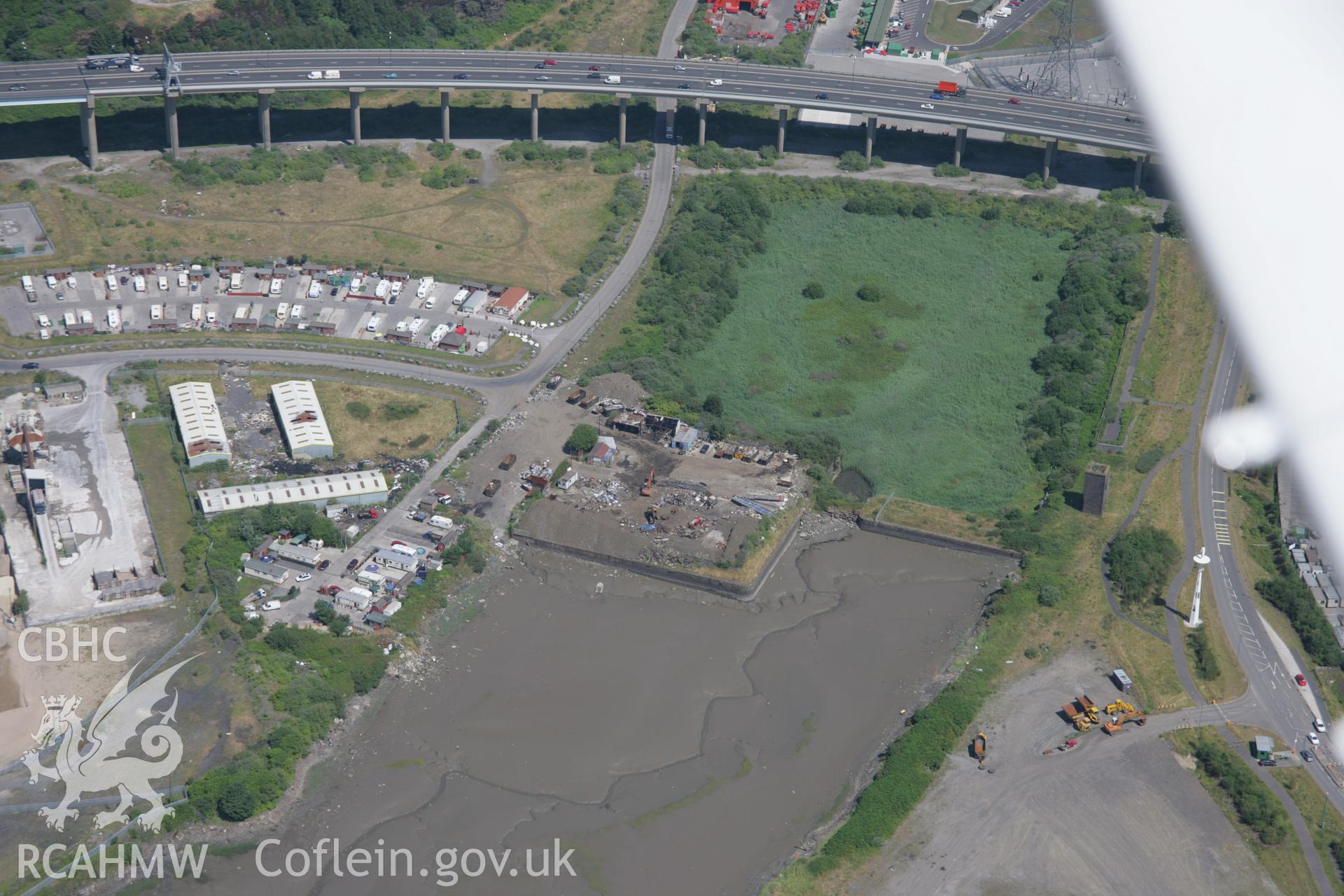 RCAHMW colour oblique aerial photograph of Briton Ferry Dock Entrance. Taken on 24 July 2006 by Toby Driver.