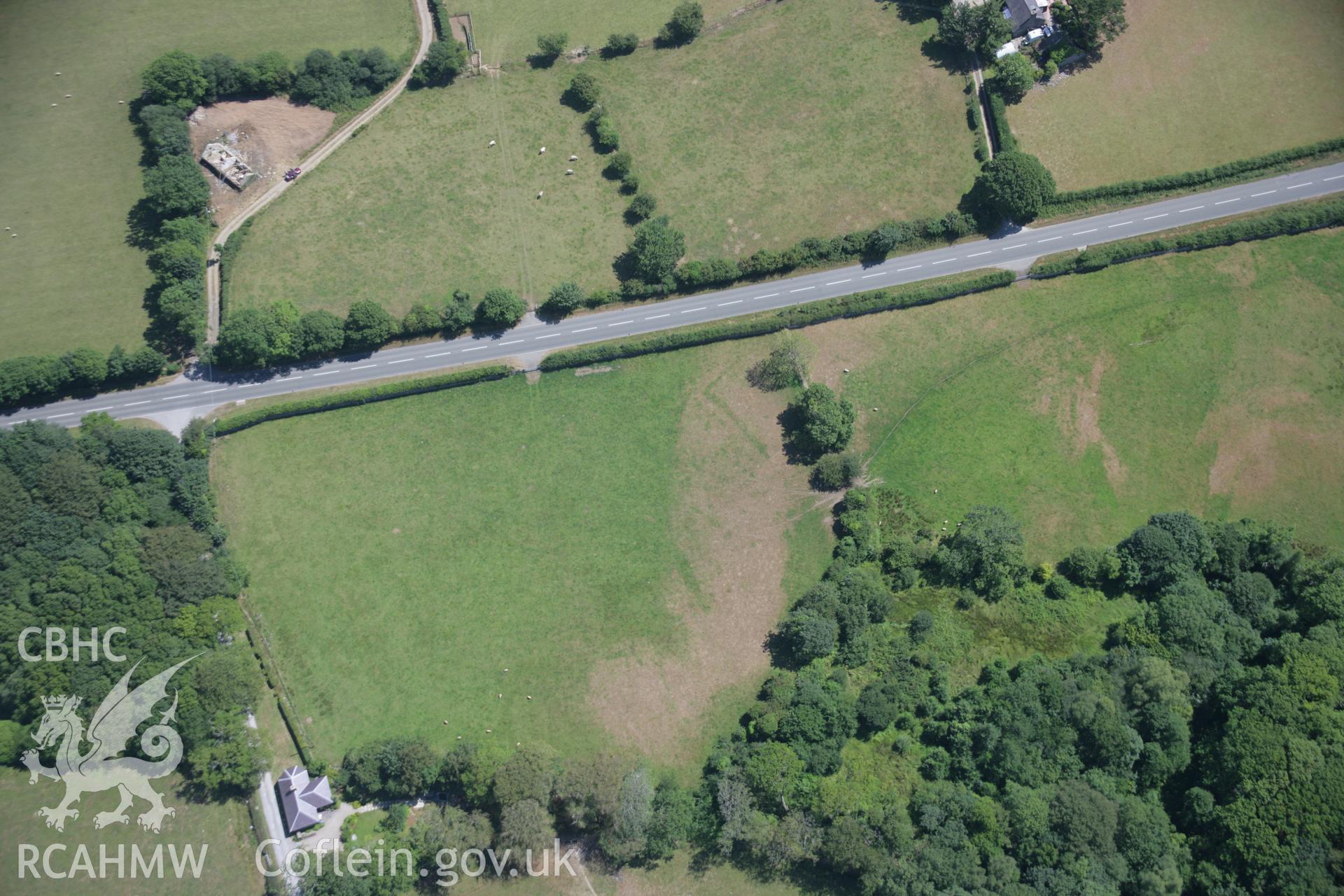 RCAHMW colour oblique aerial photograph of Castell Gwgan cropmarks, probably representing the site of a defended enclosure. Taken on 03 August 2006 by Toby Driver.