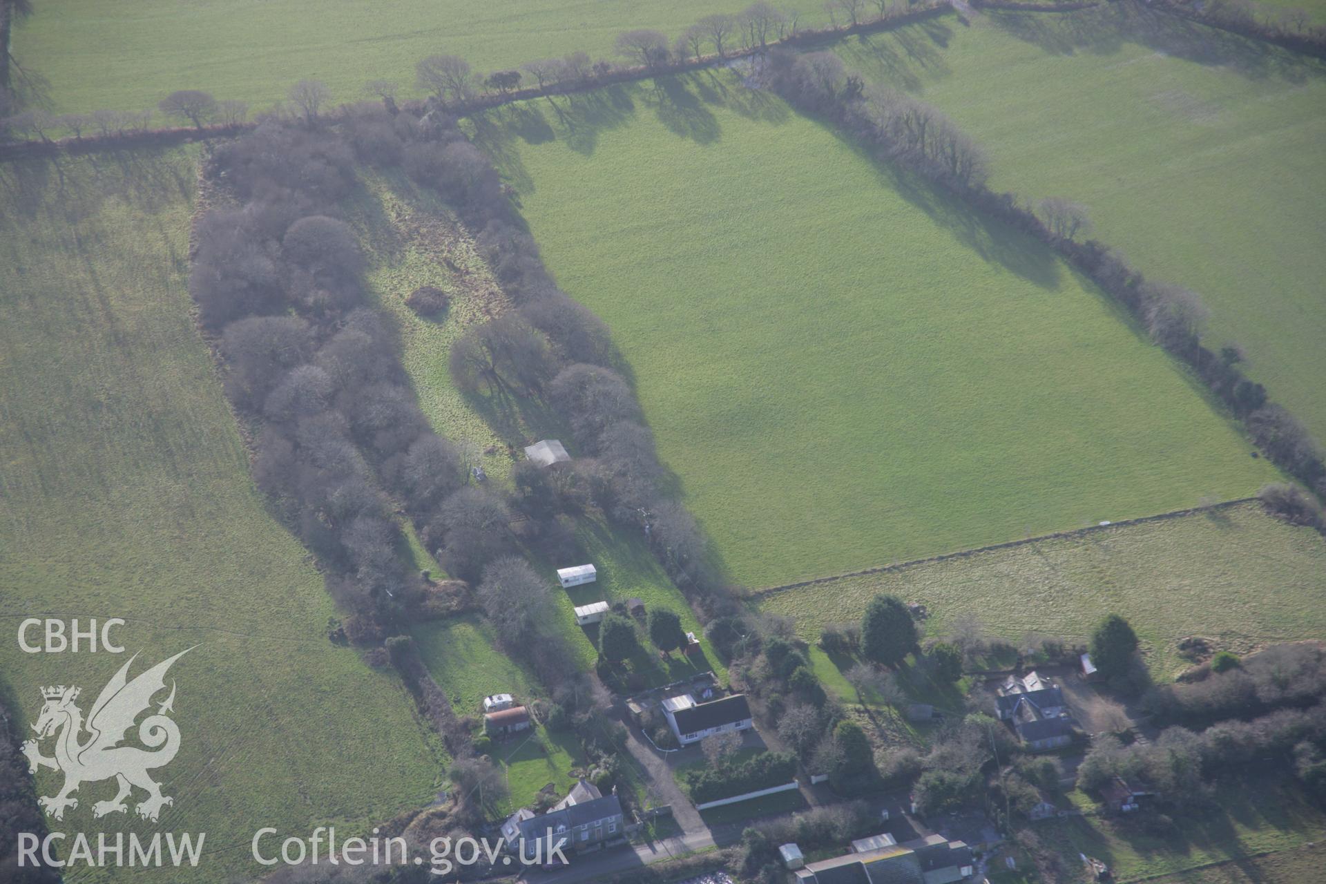RCAHMW colour oblique aerial photograph of a round barrow south of Rosemary Lane from the north-east. Taken on 11 January 2006 by Toby Driver.