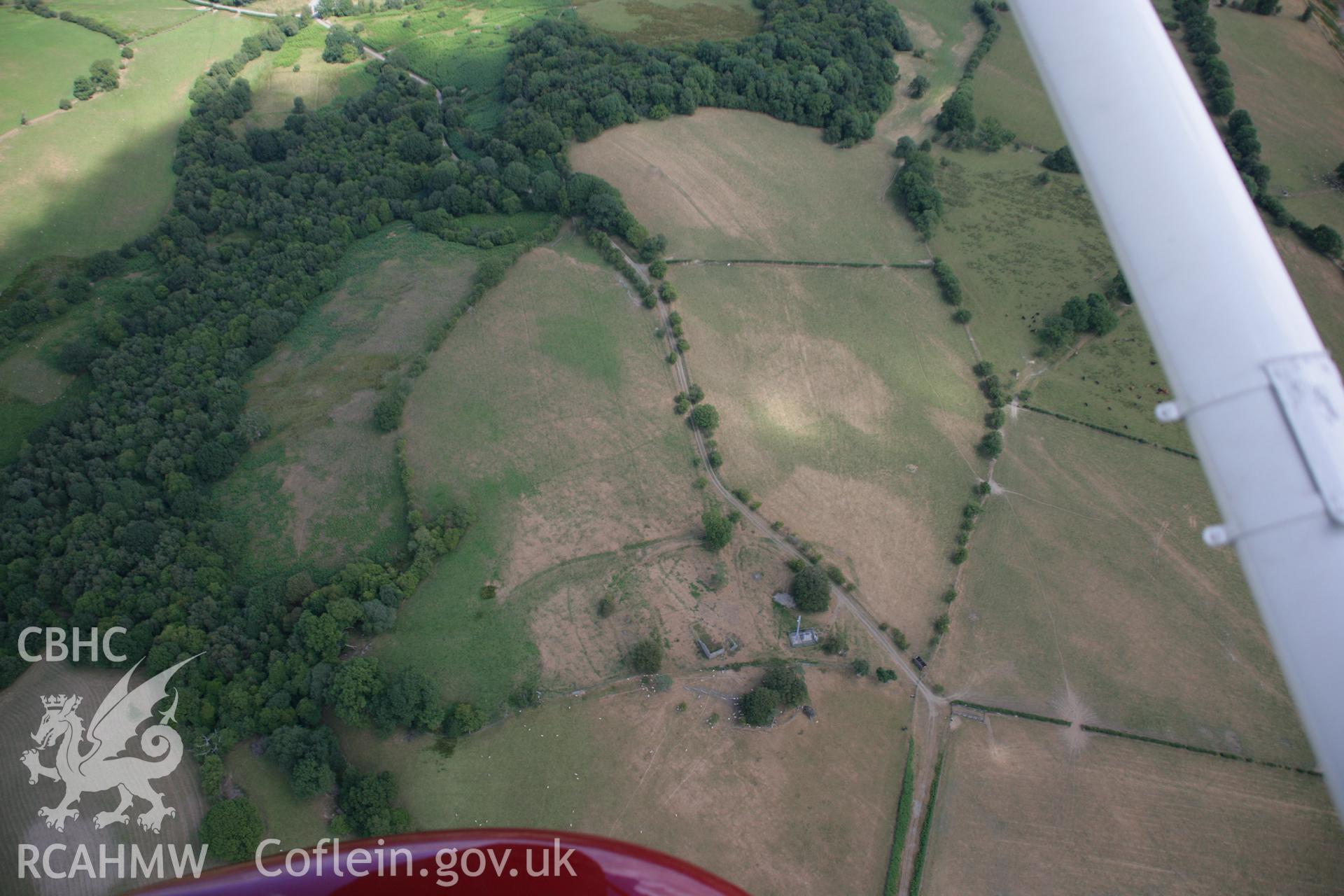 RCAHMW colour oblique aerial photograph of Treflys Defended Enclosure and Earthworks showing as cropmarks. Taken on 27 July 2006 by Toby Driver.
