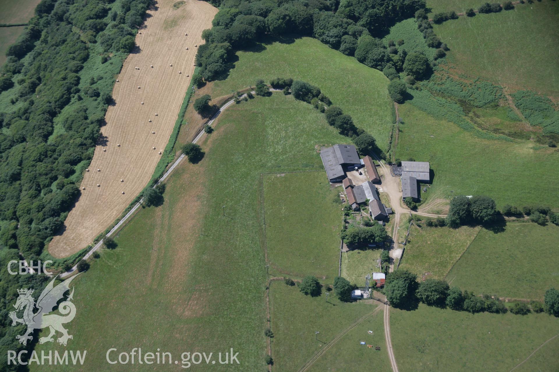 RCAHMW colour oblique aerial photograph of Ton Mawr Farm, showing earthworks that may be an indication of a hillfort. Taken on 24 July 2006 by Toby Driver.