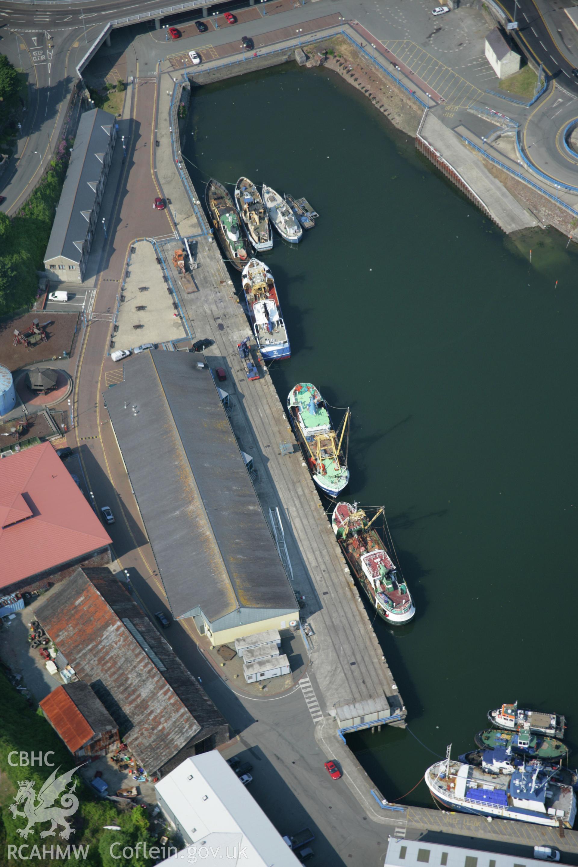RCAHMW colour oblique aerial photograph of Milford Haven Dockyard, viewed from the south. Taken on 08 June 2006 by Toby Driver.