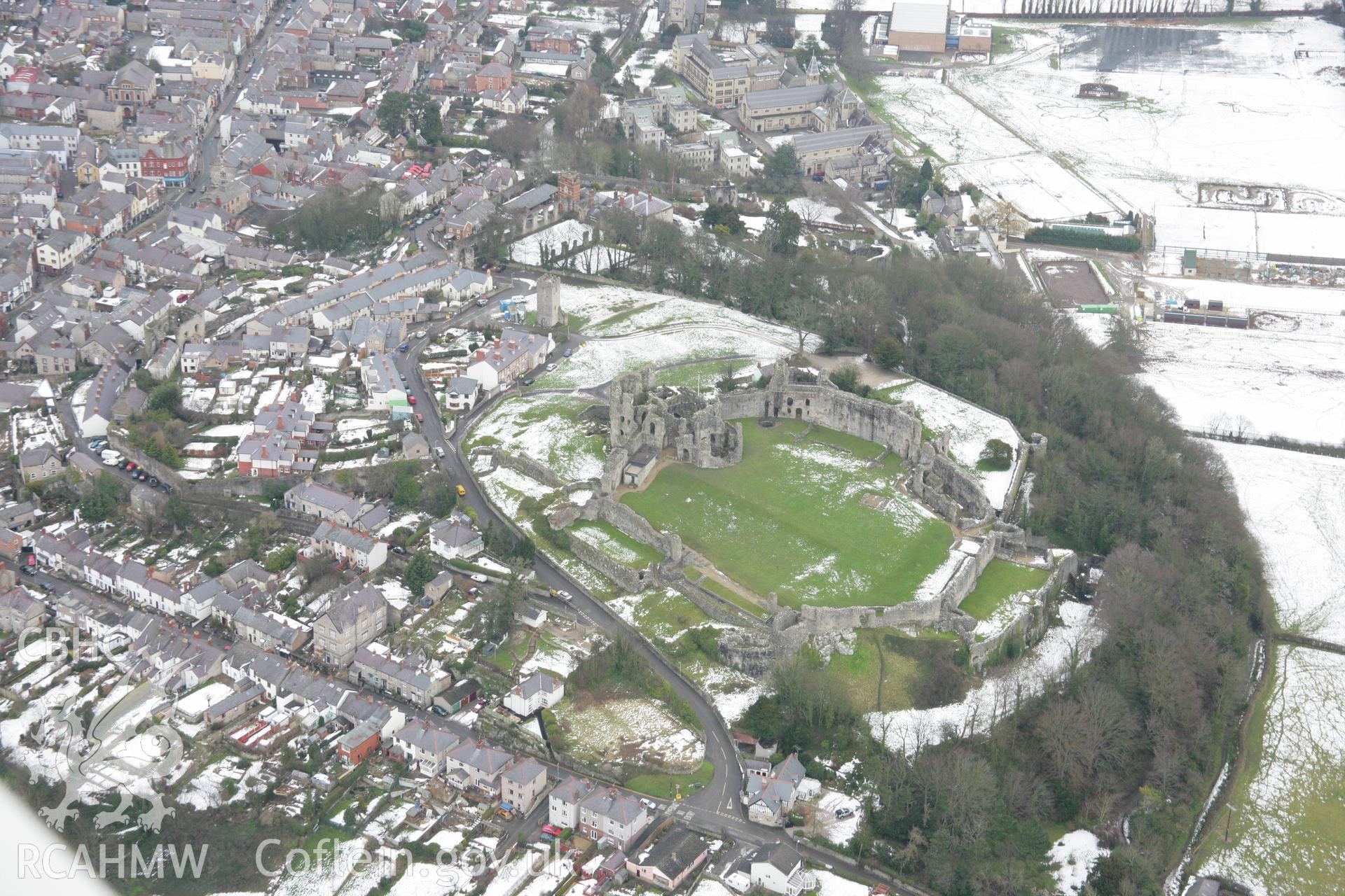 RCAHMW colour oblique aerial photograph of Denbigh Castle, with snow, viewed from the west. Taken on 06 March 2006 by Toby Driver.