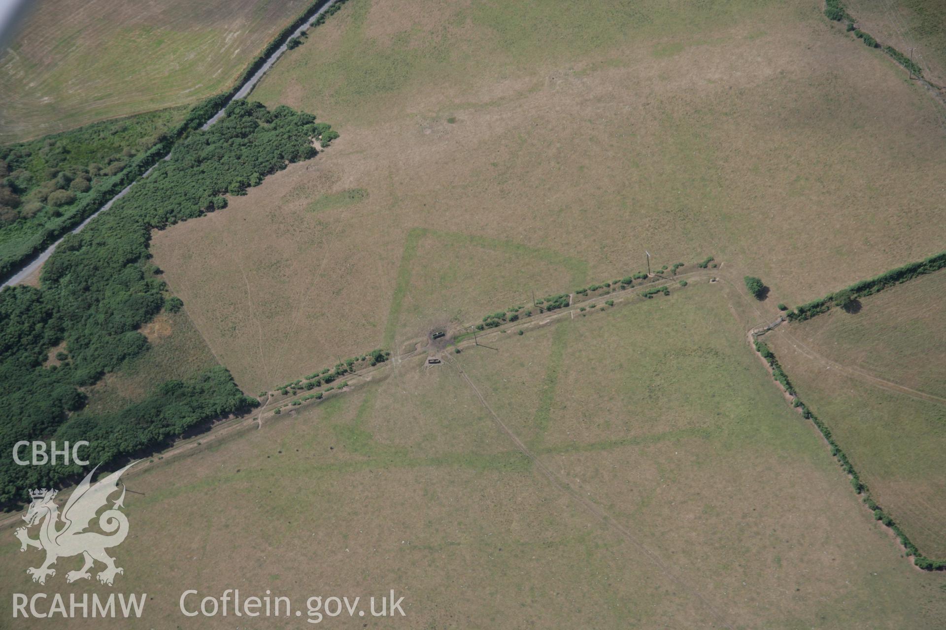 RCAHMW colour oblique aerial photograph of a cropmark Enclosure southeast of Traian, Boduan viewed from the east. Taken on 03 August 2006 by Toby Driver.