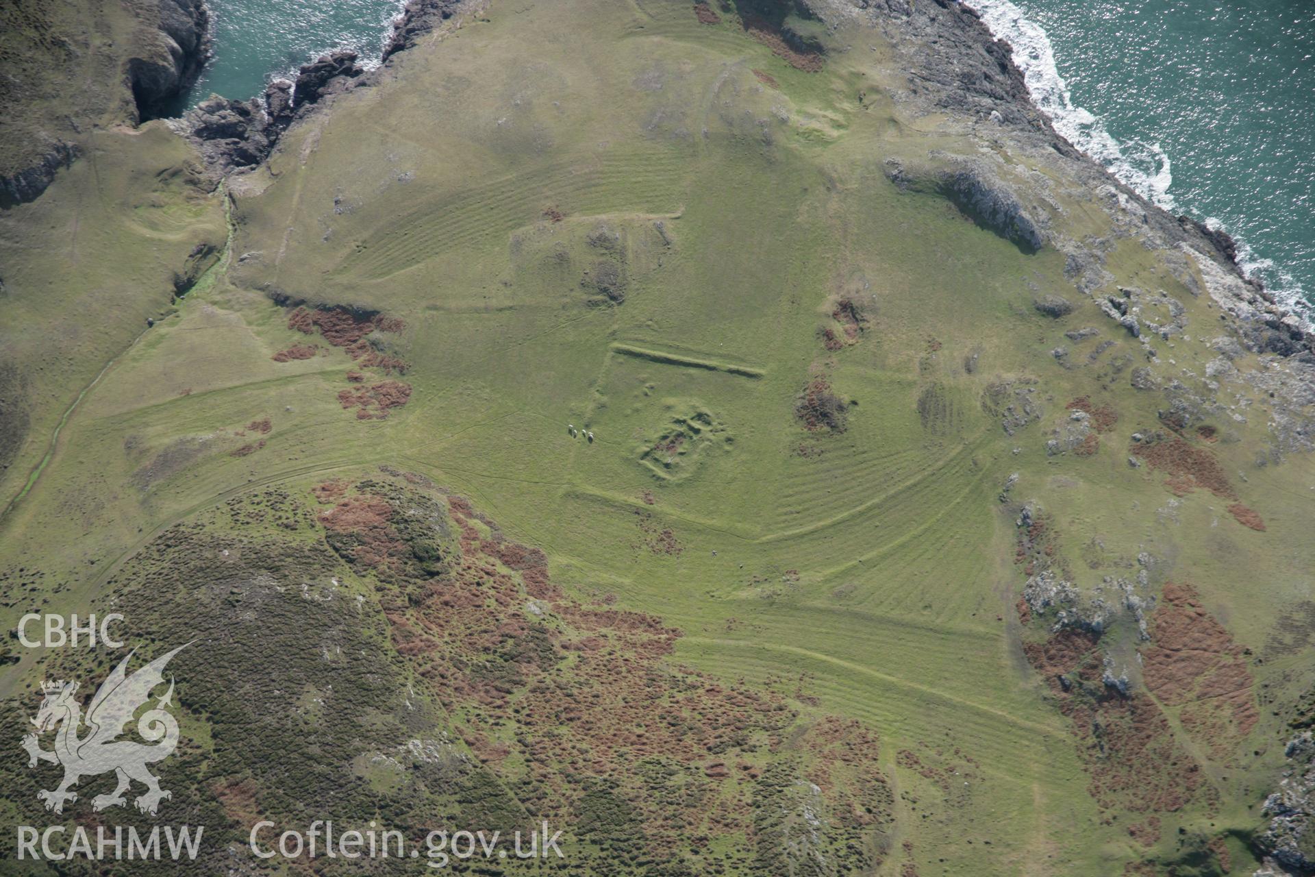 RCAHMW colour oblique aerial photograph of St Marys Church earthworks, viewed from the north-east. Taken on 09 February 2006 by Toby Driver
