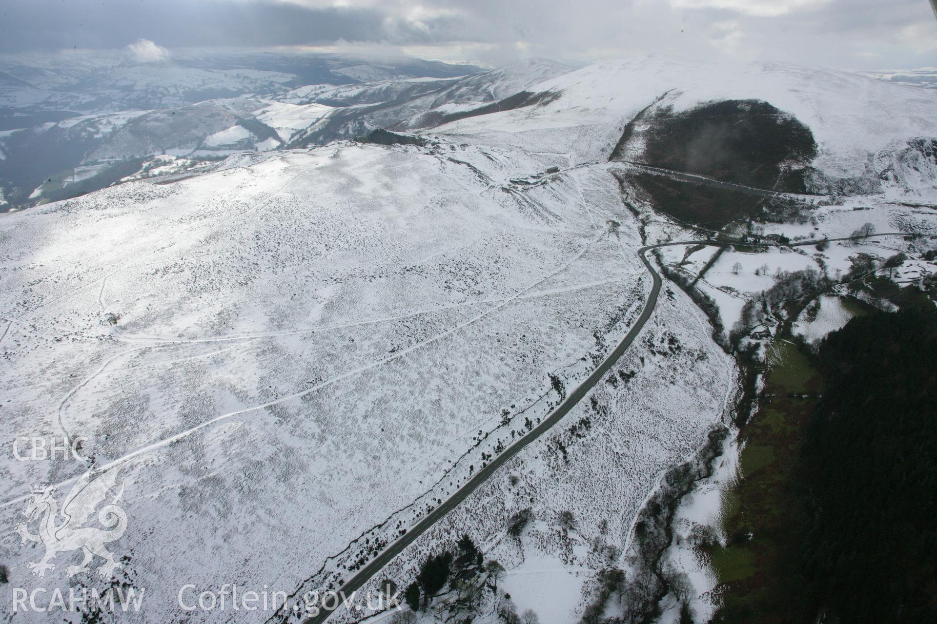 RCAHMW colour oblique aerial photograph of Clogau Slate Quarry from the east showing the surrounding landscape and the Horseshoe Pass. Taken on 06 March 2006 by Toby Driver.