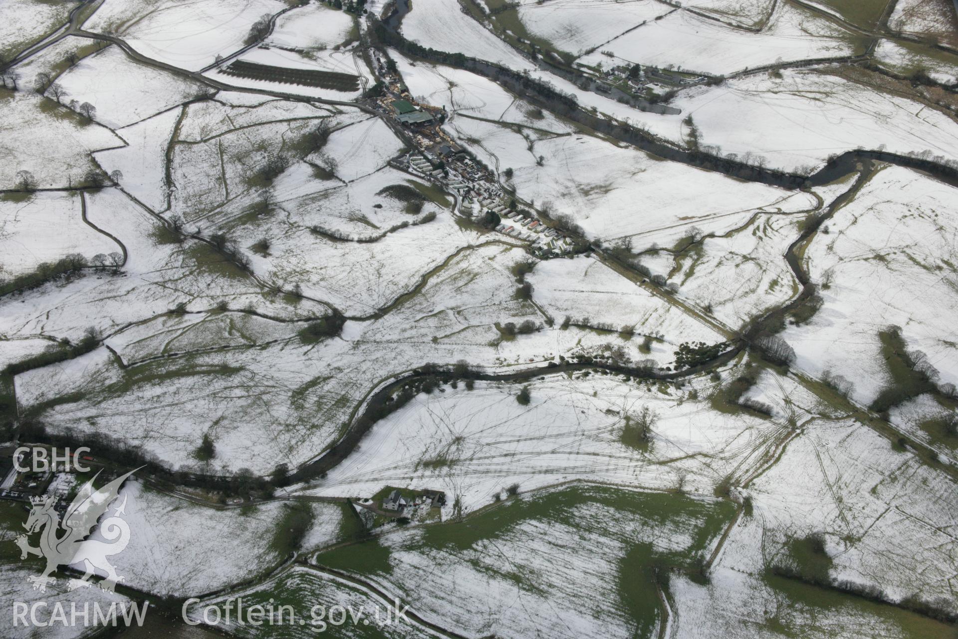 RCAHMW colour oblique aerial photograph of Llandrillo station with view of fields and embankment from north-east. Taken on 06 March 2006 by Toby Driver.