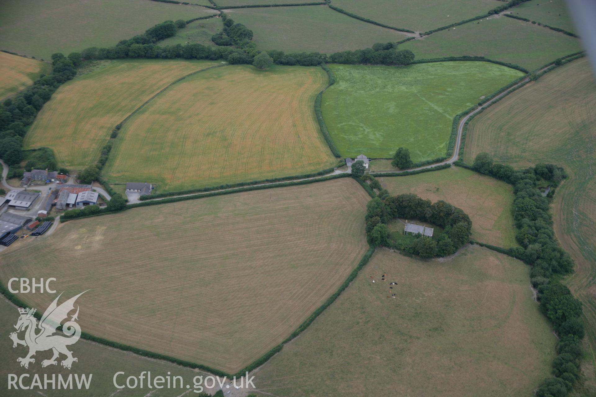 RCAHMW colour oblique aerial photograph of Llangan Church and cropmarks. Taken on 27 July 2006 by Toby Driver.