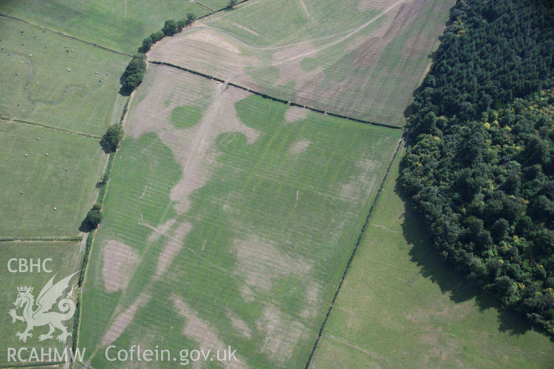 RCAHMW colour oblique aerial photograph of Llwydfaen Medieval Township, general view from north-west with parchmarks of church and building foundations, taken on 14/08/2006 by Toby Driver.