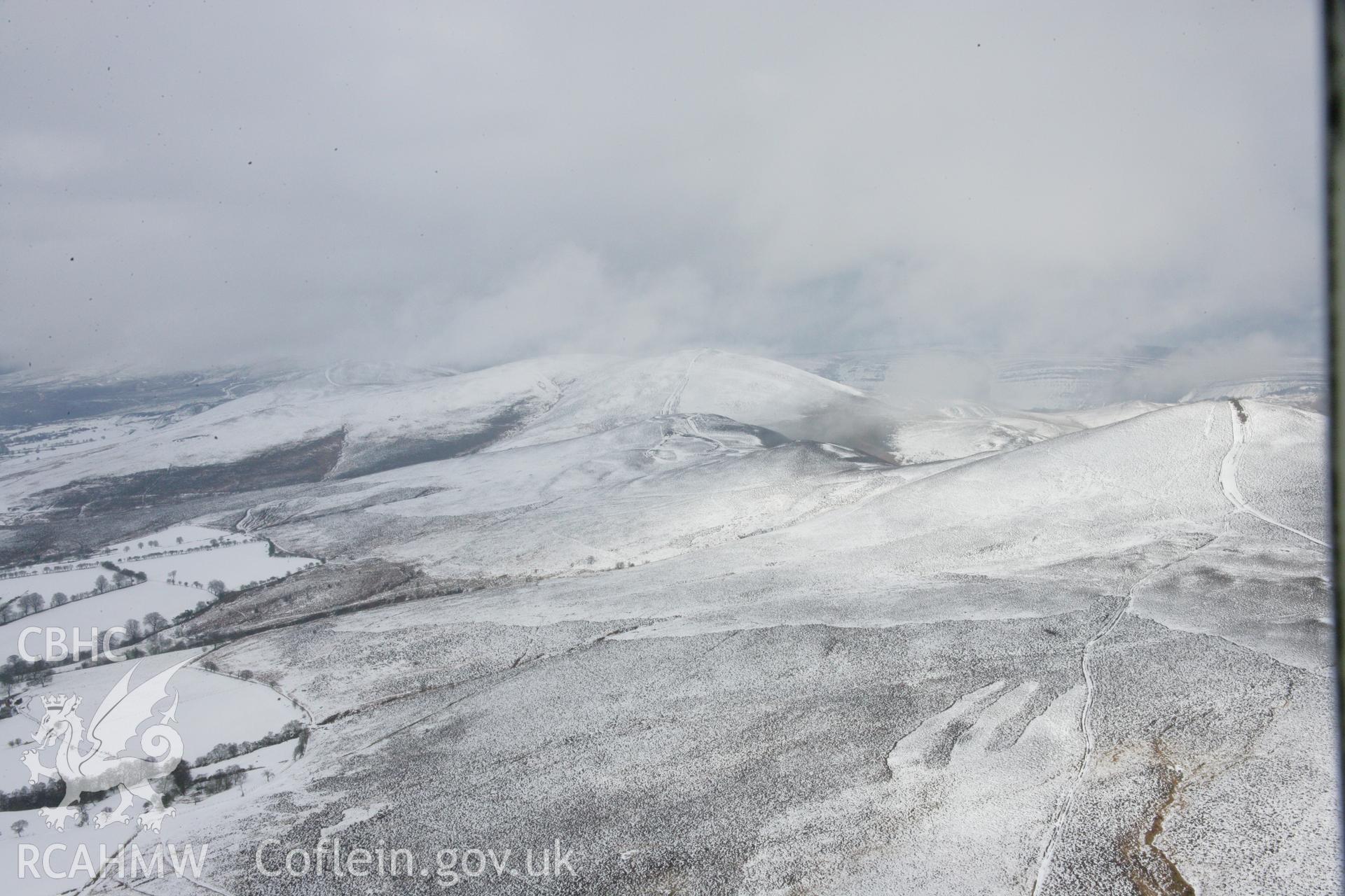 RCAHMW colour oblique aerial photograph of Moel-y-Gaer Hillfort, Llantysilio in winter landscape from the south-west. Taken on 06 March 2006 by Toby Driver.