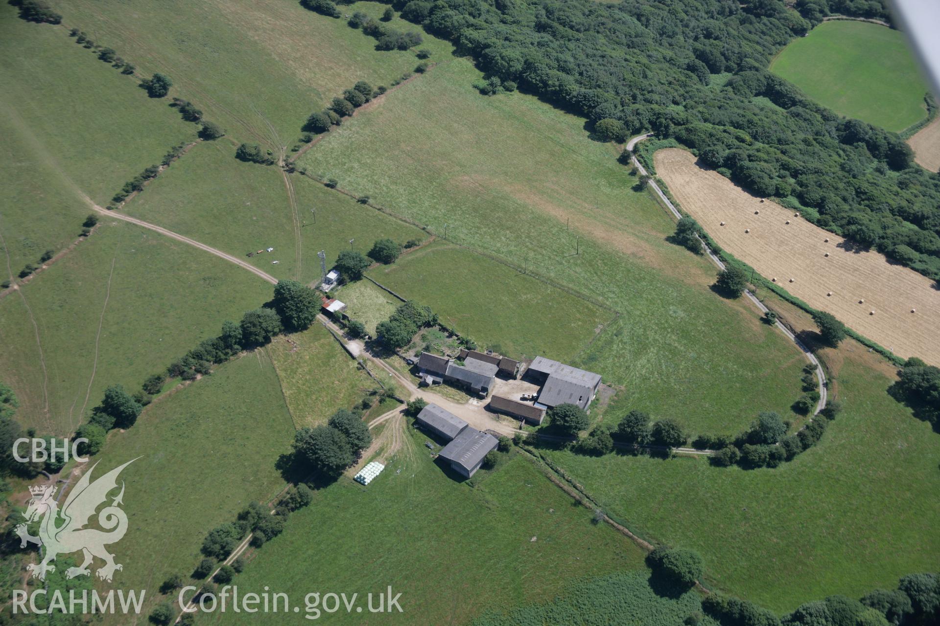 RCAHMW colour oblique aerial photograph of Ton Mawr Farm, showing earthworks that may be an indication of a hillfort. Taken on 24 July 2006 by Toby Driver.