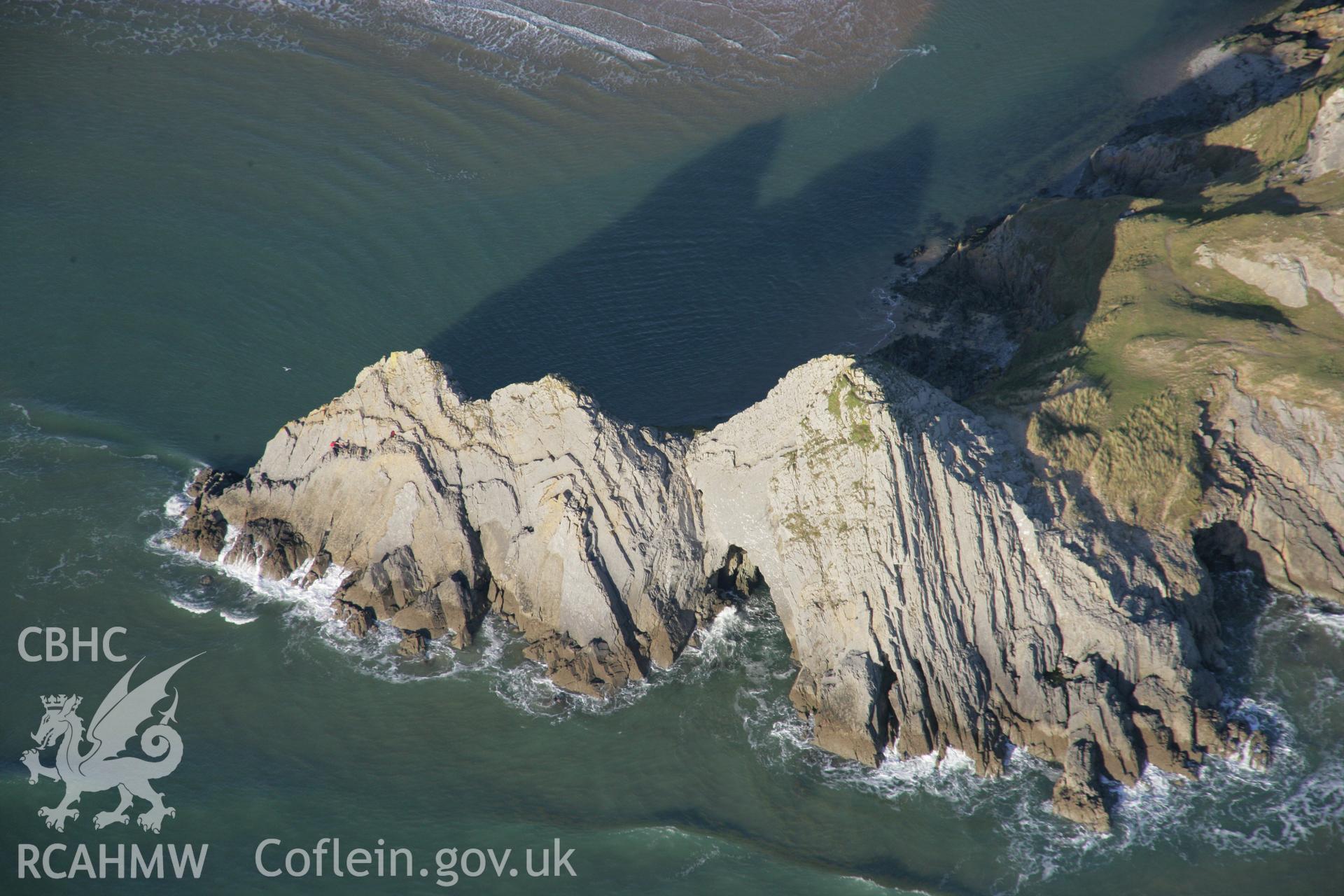 RCAHMW colour oblique aerial photograph of Three Cliffs Bay from the south-east showing the cliffs and caves. Taken on 26 January 2006 by Toby Driver.