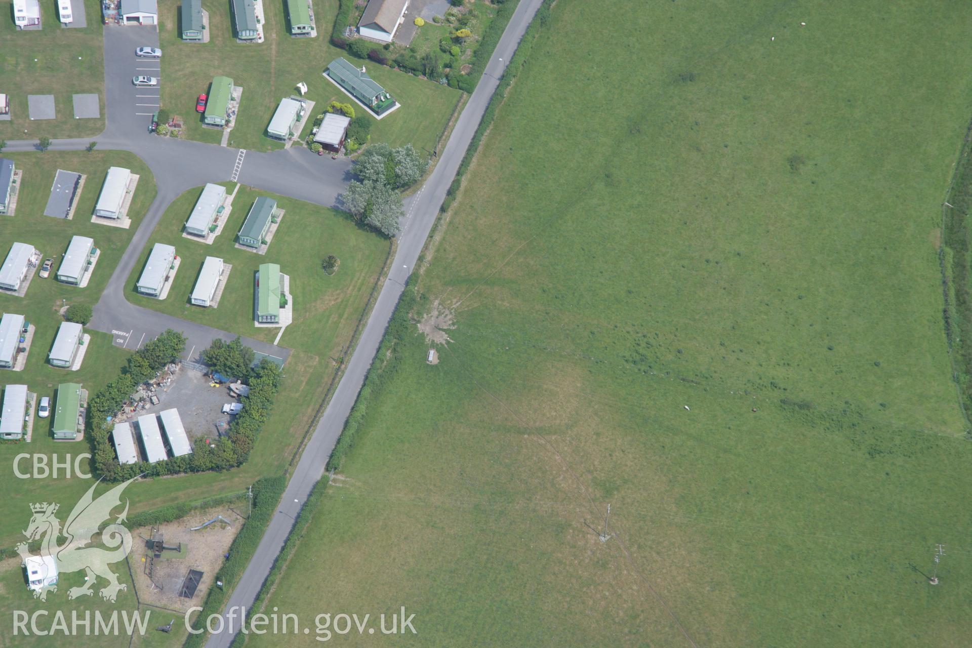 RCAHMW colour oblique aerial photograph of Glan-y-Mor Enclosure. Taken on 04 July 2006 by Toby Driver.