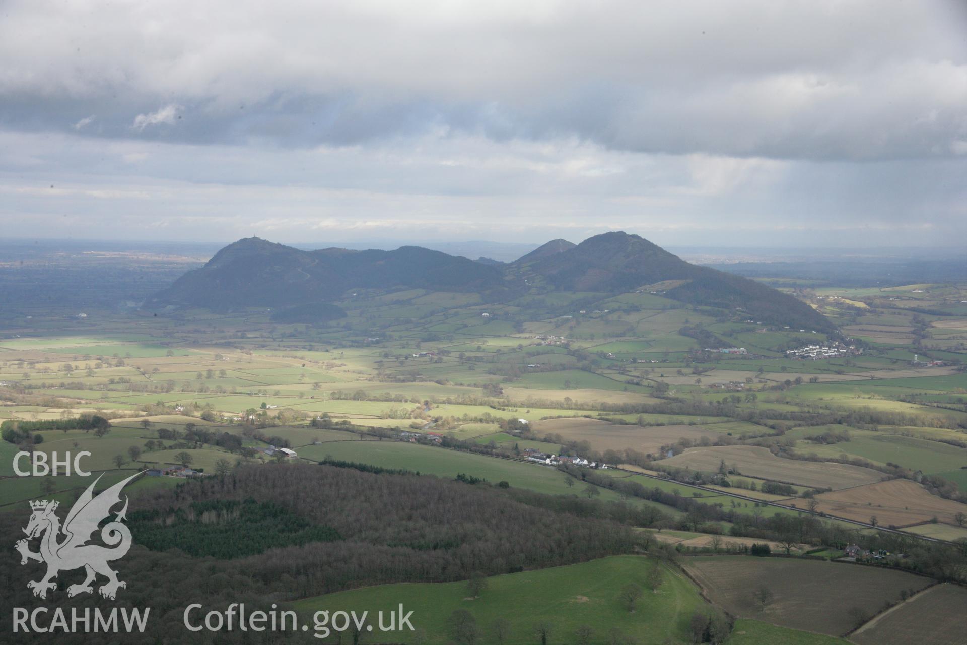 RCAHMW colour oblique aerial photograph of The Breidden Hillfort and surrounding landscape from the west. Taken on 06 March 2006 by Toby Driver.