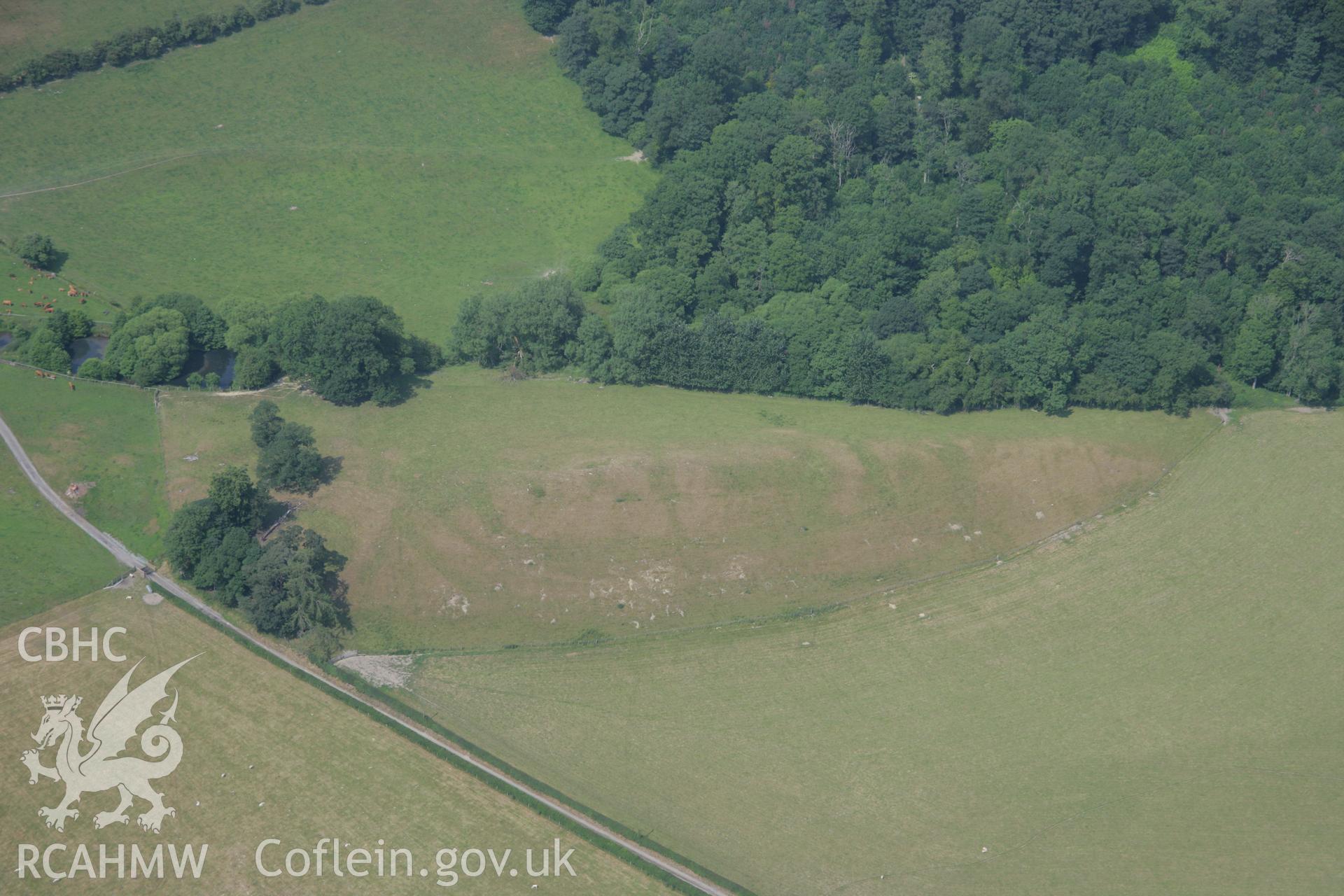 RCAHMW colour oblique aerial photograph of Plas Uchaf Enclosure. Taken on 04 July 2006 by Toby Driver.