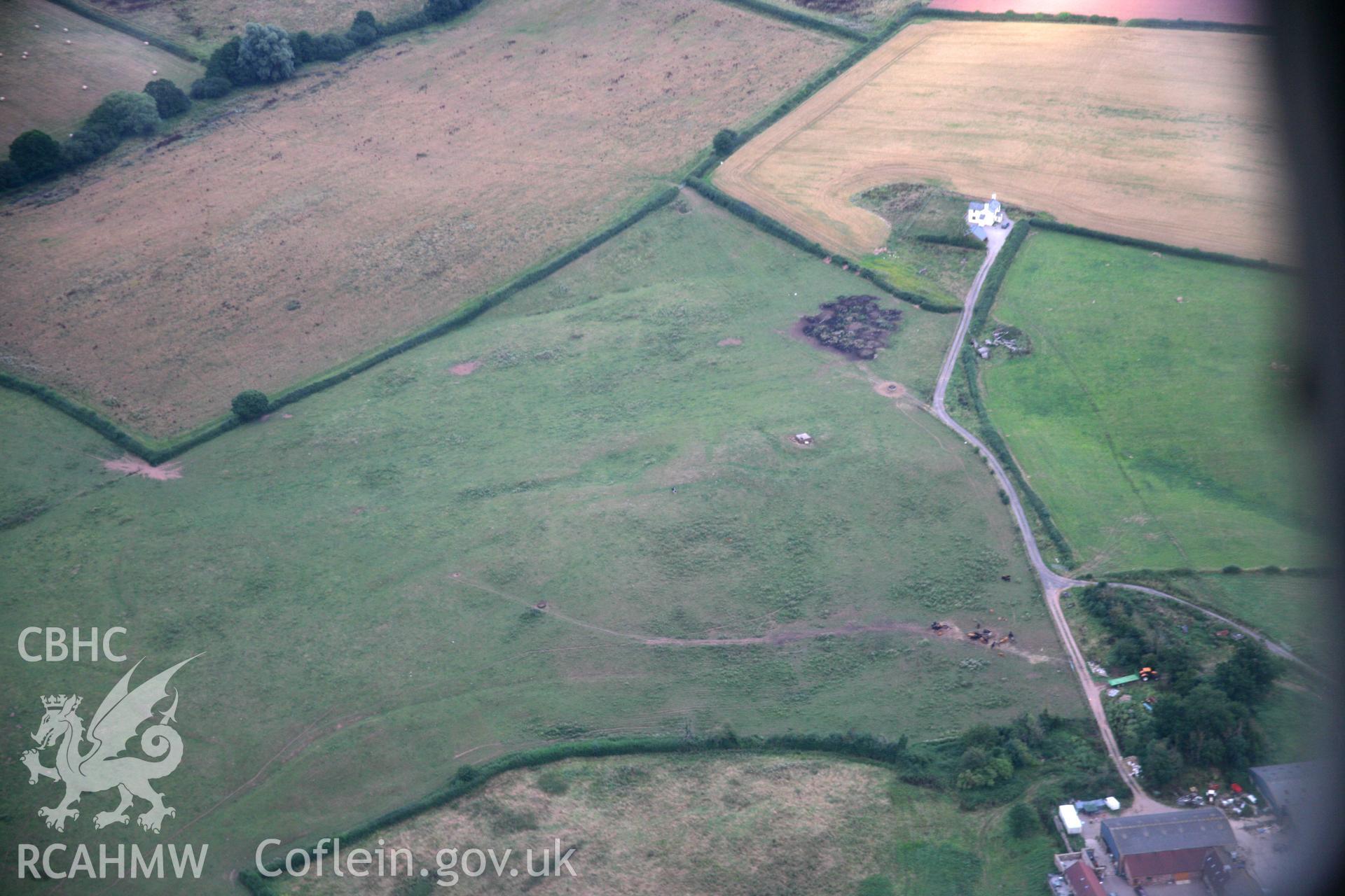 RCAHMW colour oblique aerial photograph of siege earthworks north-east of Raglan Castle. Taken on 05 August 2006 by Toby Driver